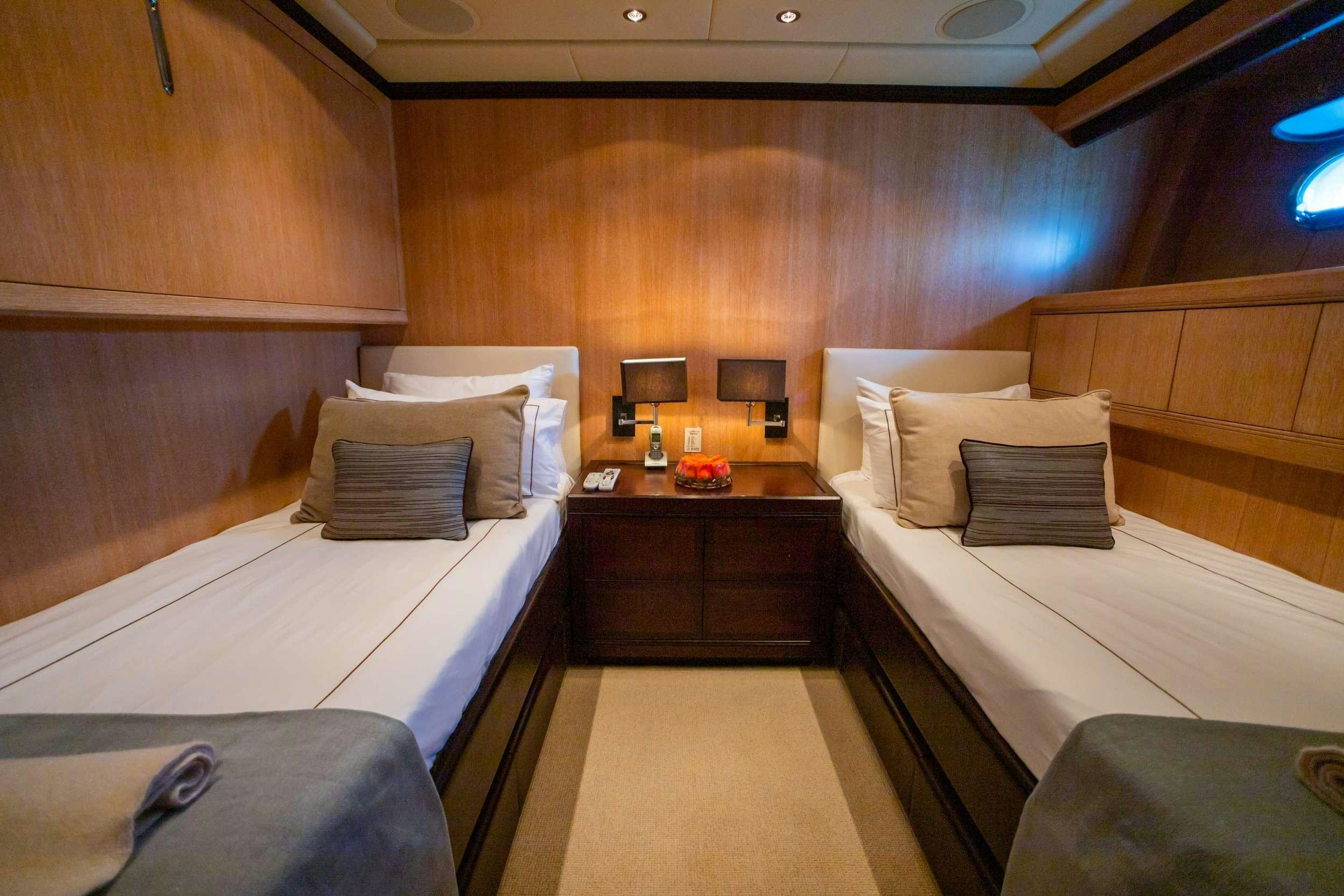 a room with a bed and a desk aboard FREE SPIRIT Yacht for Charter