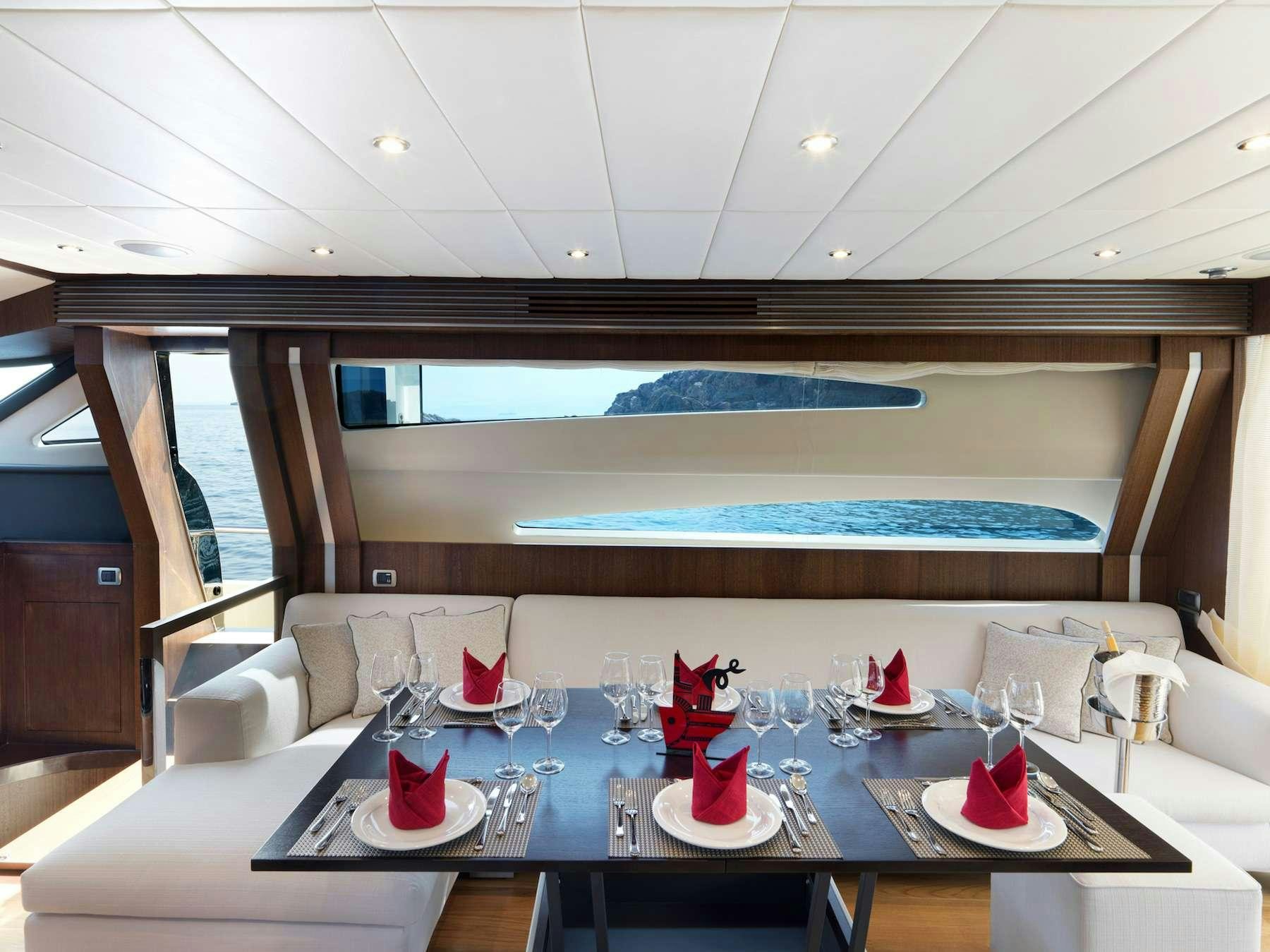 a room with a table and chairs aboard RUBY Yacht for Charter