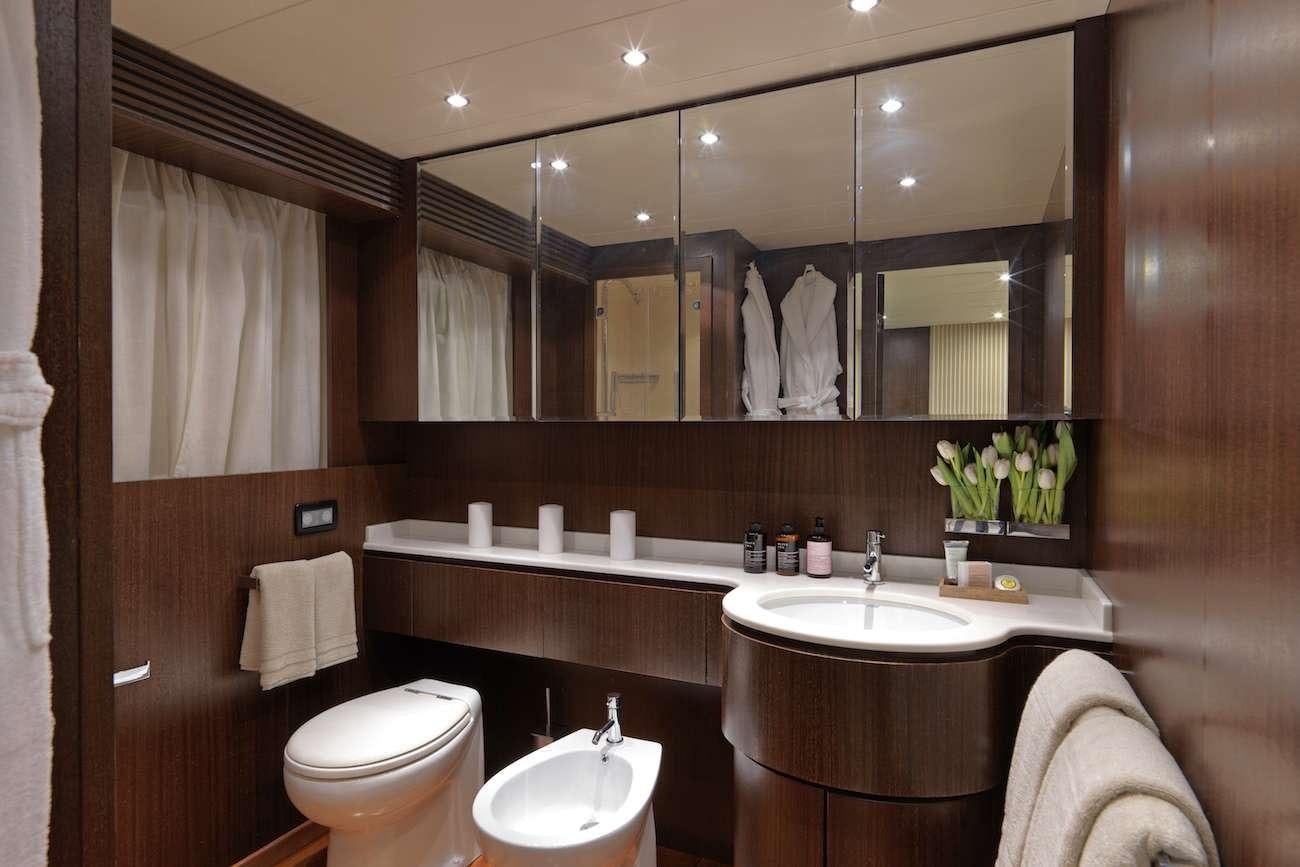 a bathroom with a large mirror aboard RUBY Yacht for Charter