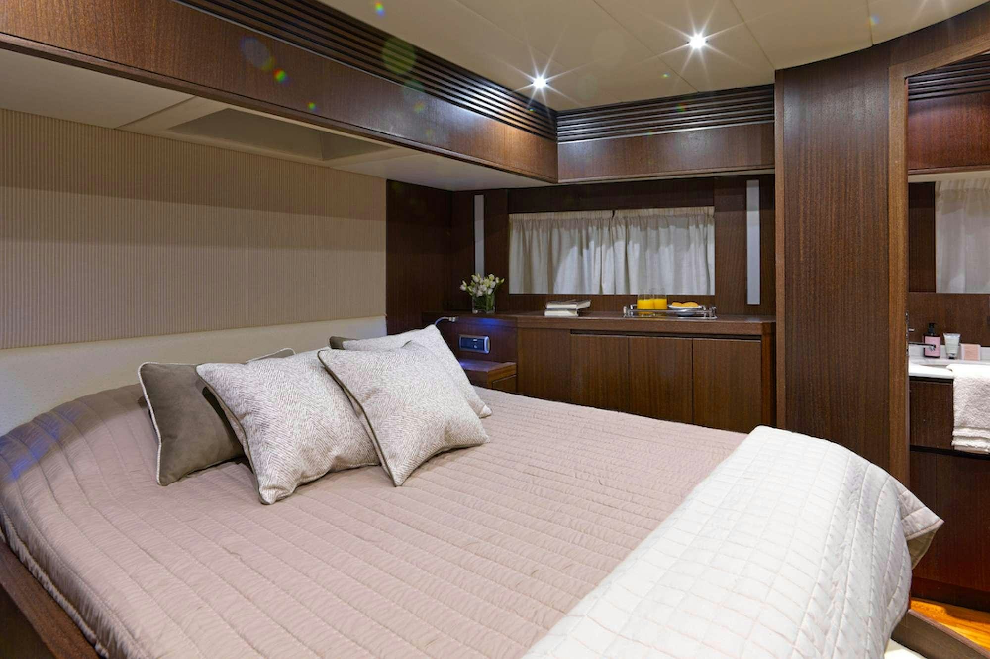 a bed with pillows on it aboard RUBY Yacht for Charter