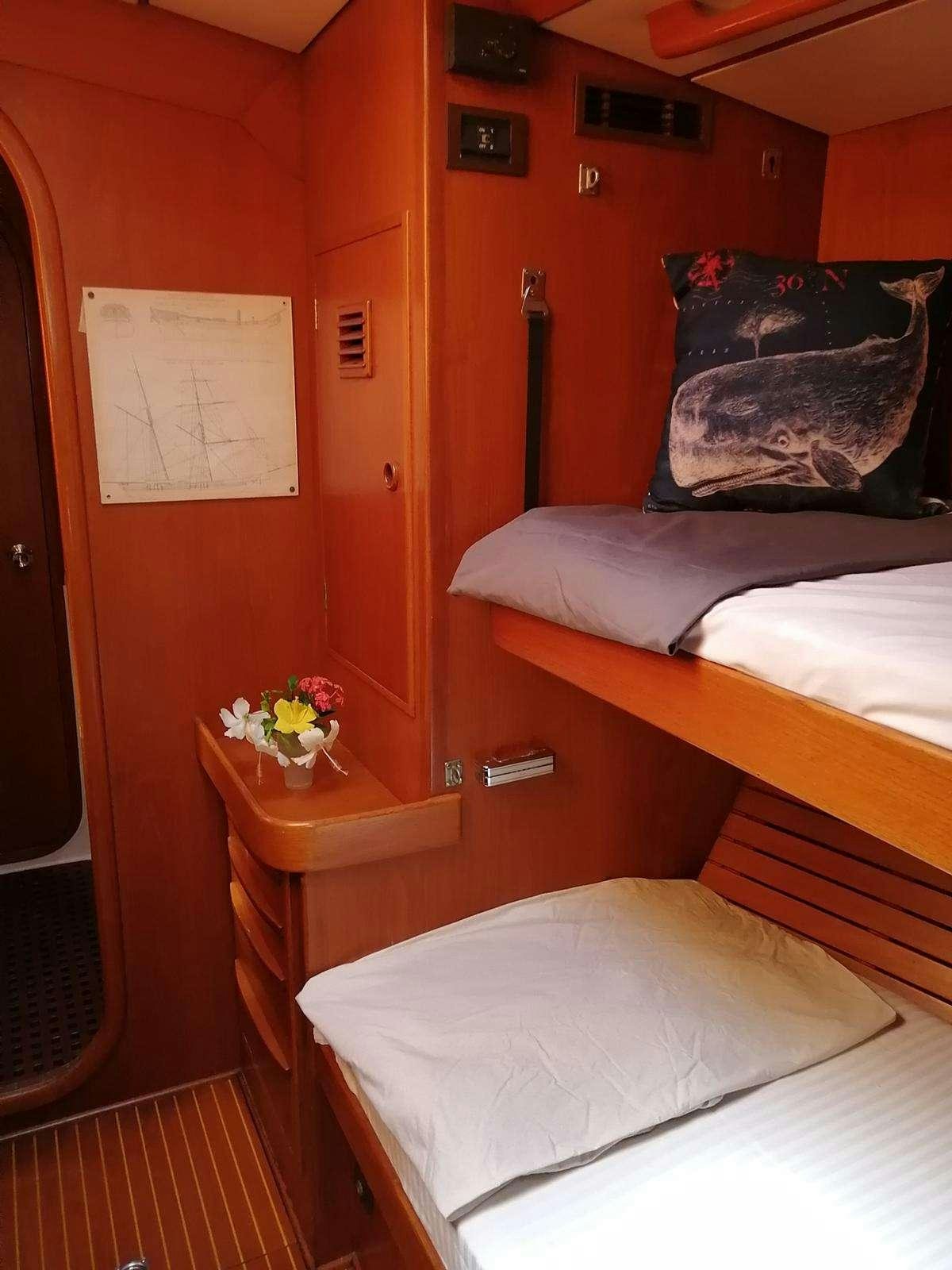 a room with a bed and a desk aboard AURORA Yacht for Charter