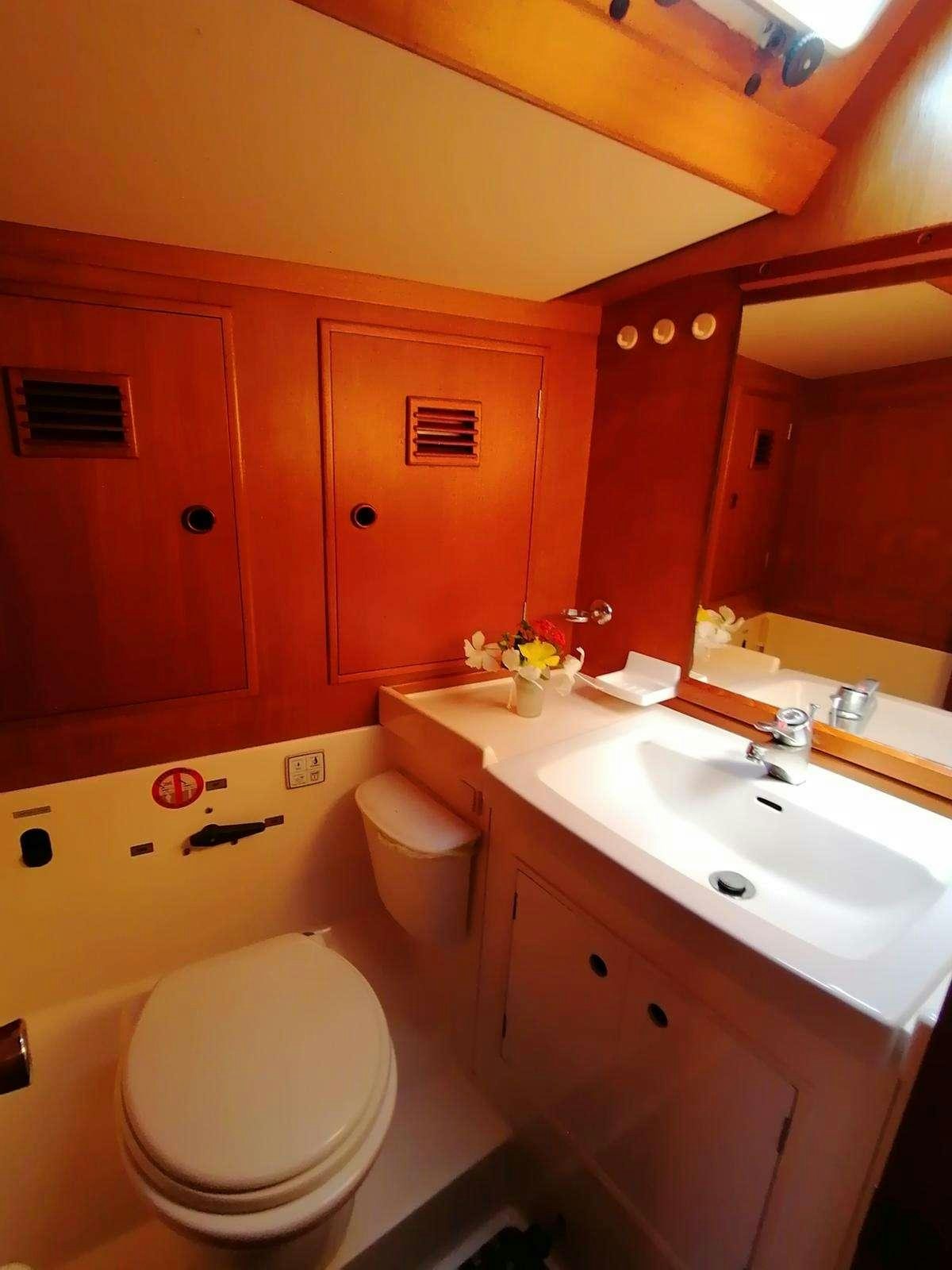 a bathroom with orange walls aboard AURORA Yacht for Charter