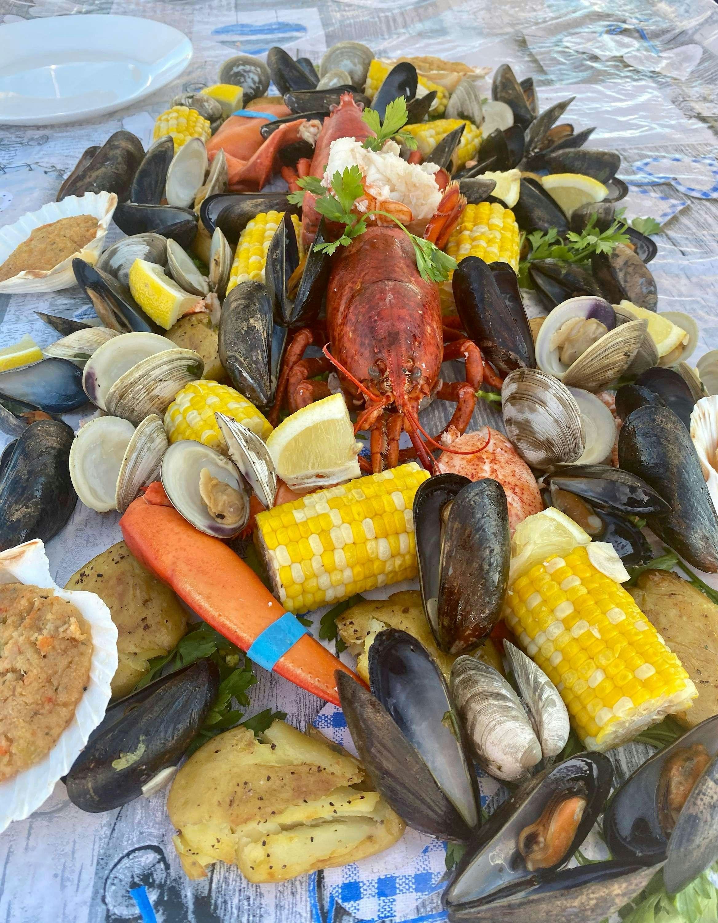 a pile of seafood on a beach aboard AURORA Yacht for Charter