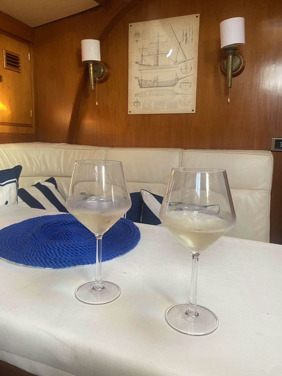 a group of wine glasses on a table aboard AURORA Yacht for Charter