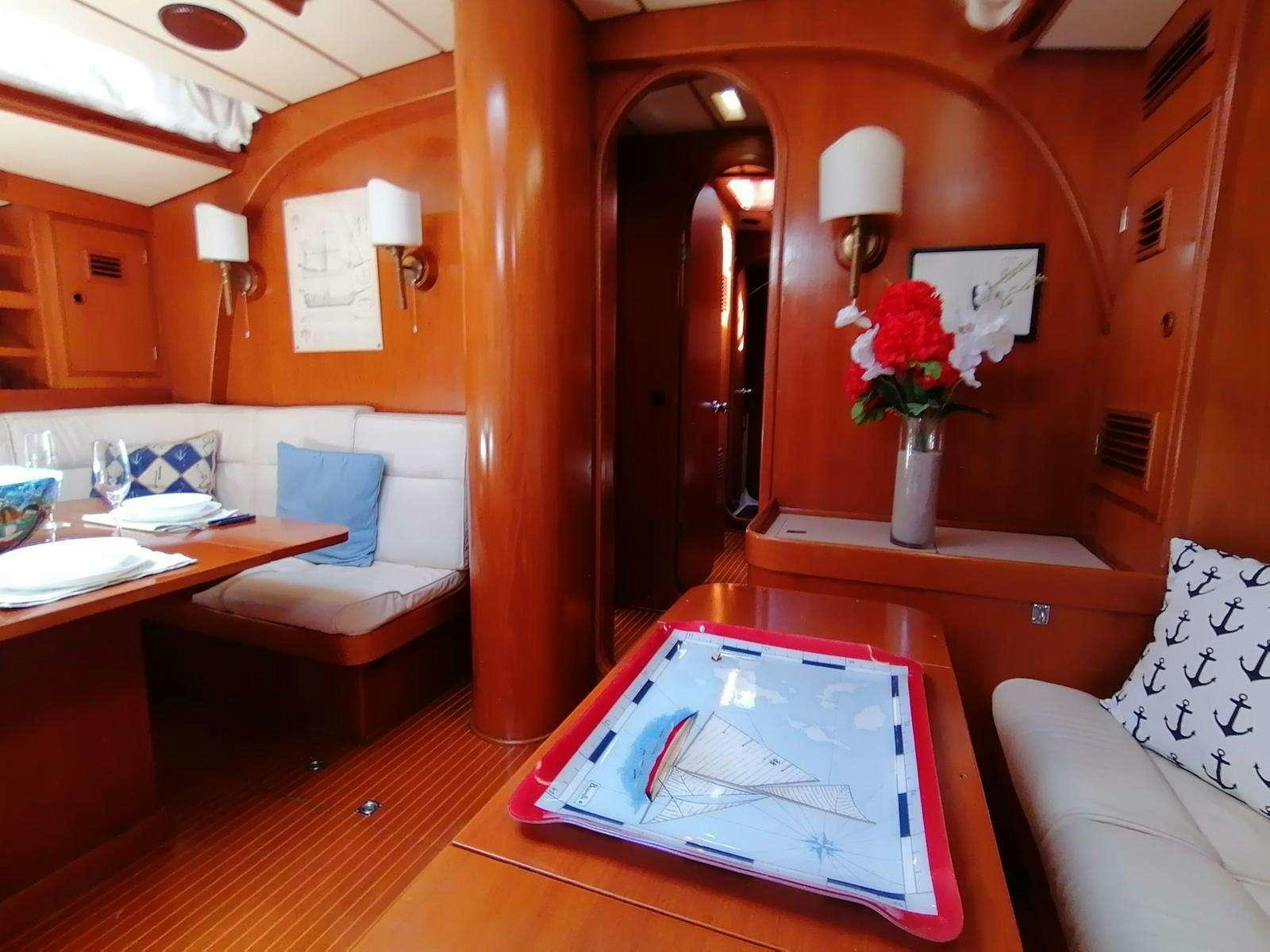 a room with a table and couch aboard AURORA Yacht for Charter