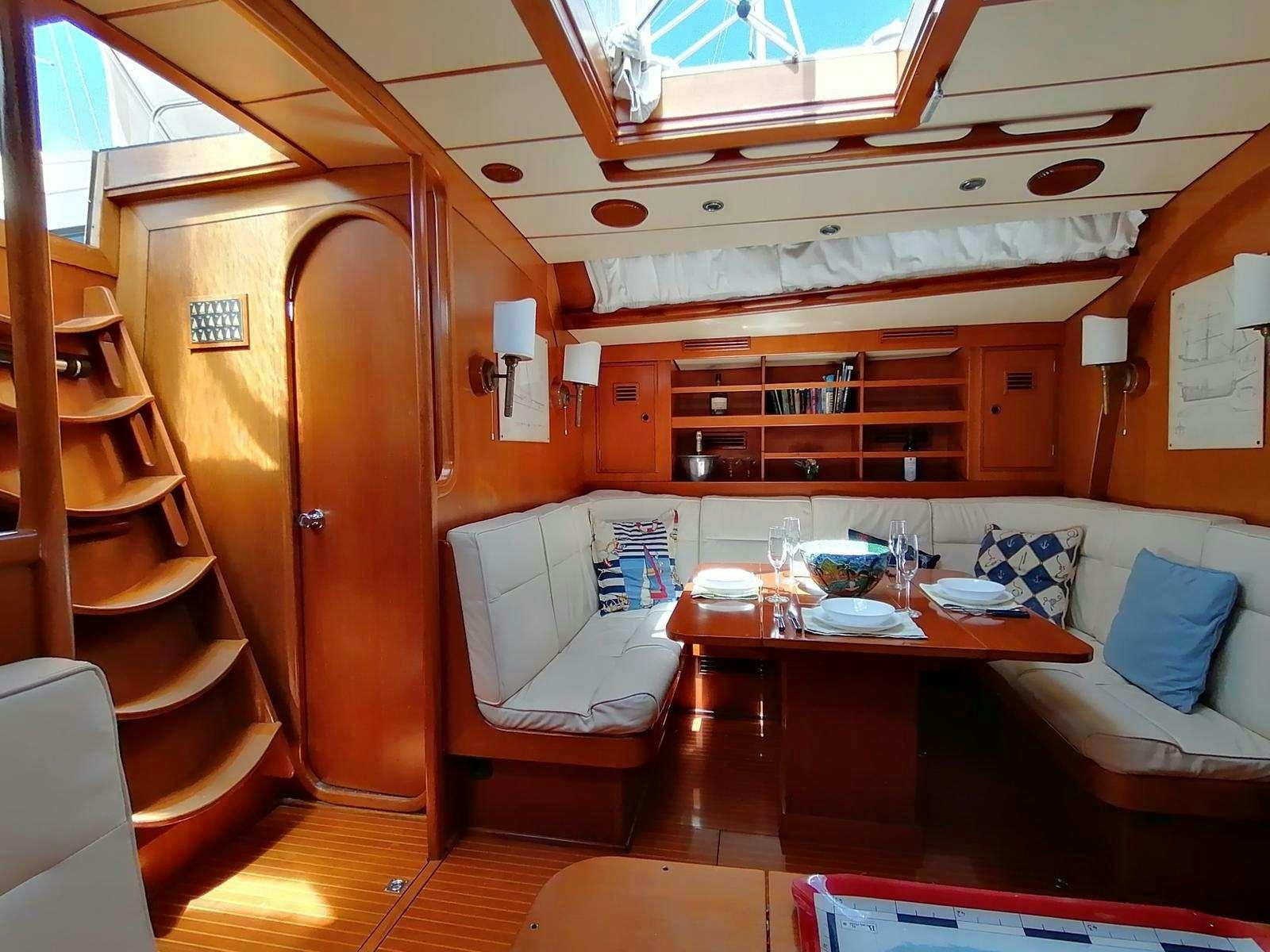 a room with a table and chairs aboard AURORA Yacht for Charter