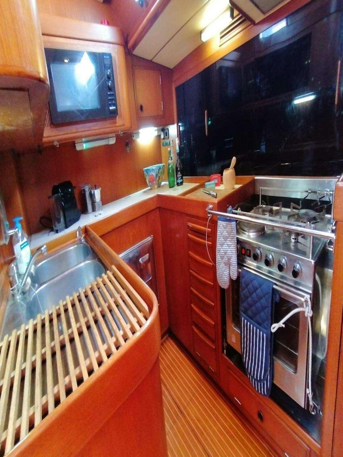 a kitchen with wooden cabinets aboard AURORA Yacht for Charter