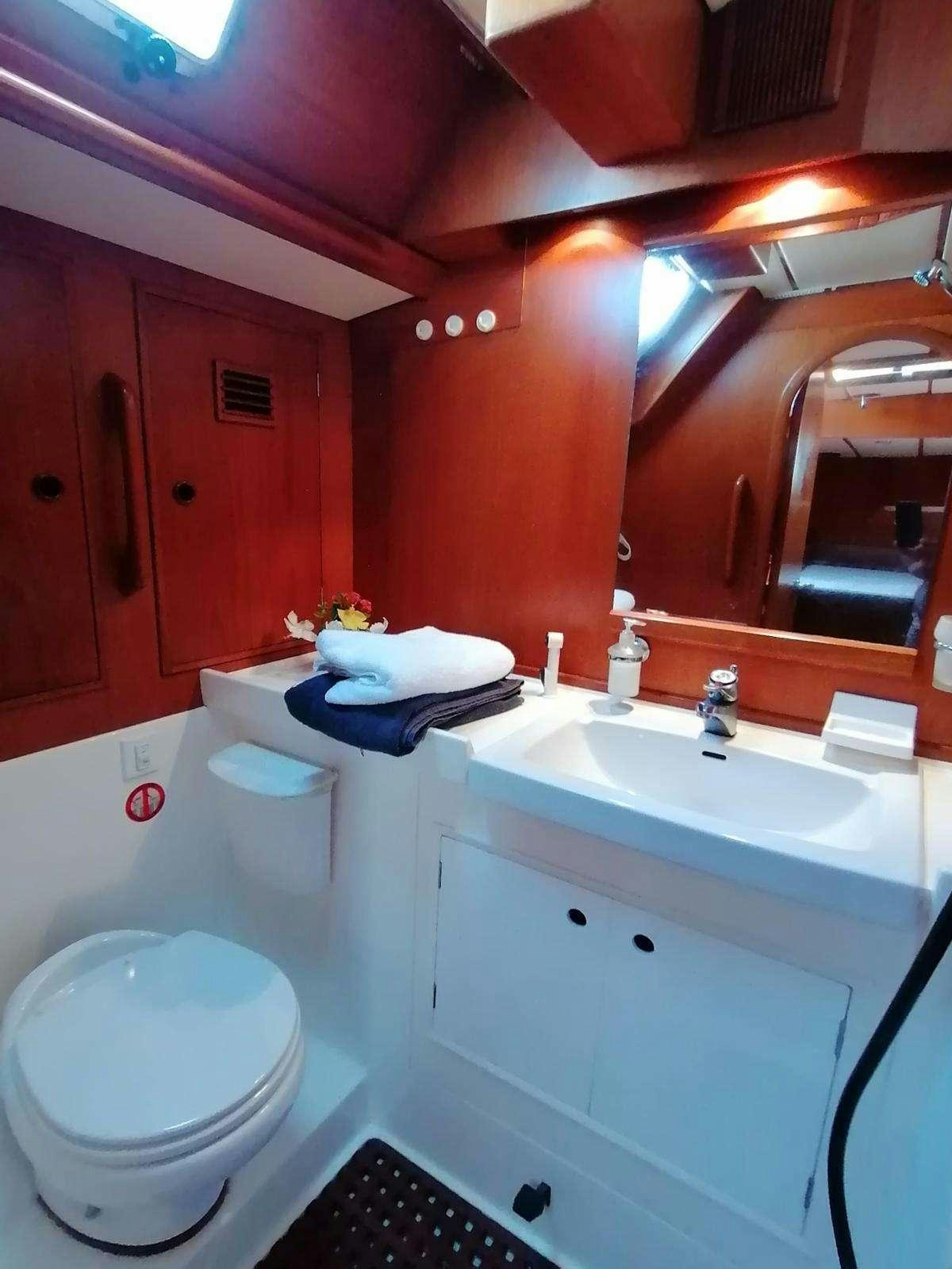 a bathroom with a toilet and sink aboard AURORA Yacht for Charter