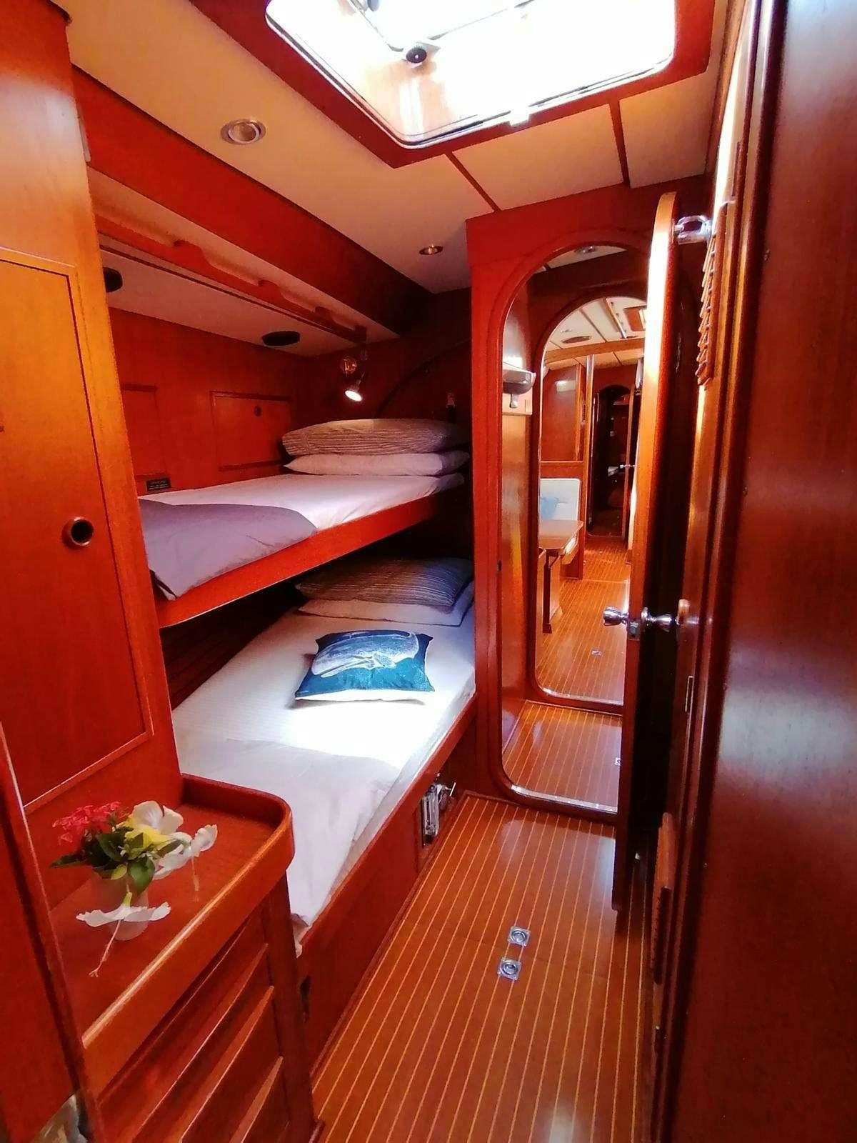 a room with a bed and a door aboard AURORA Yacht for Charter