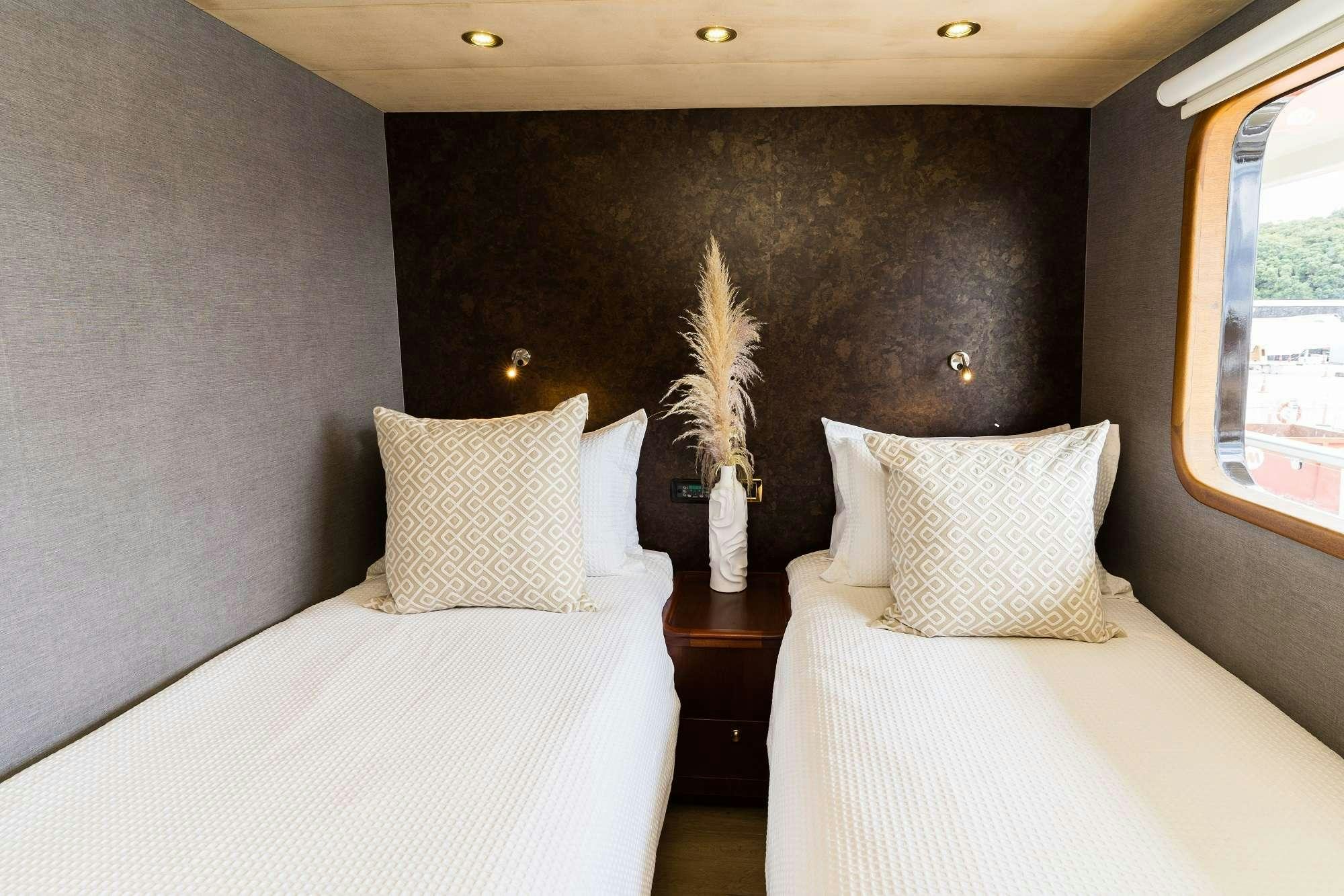 a room with two beds aboard IRAMA Yacht for Charter