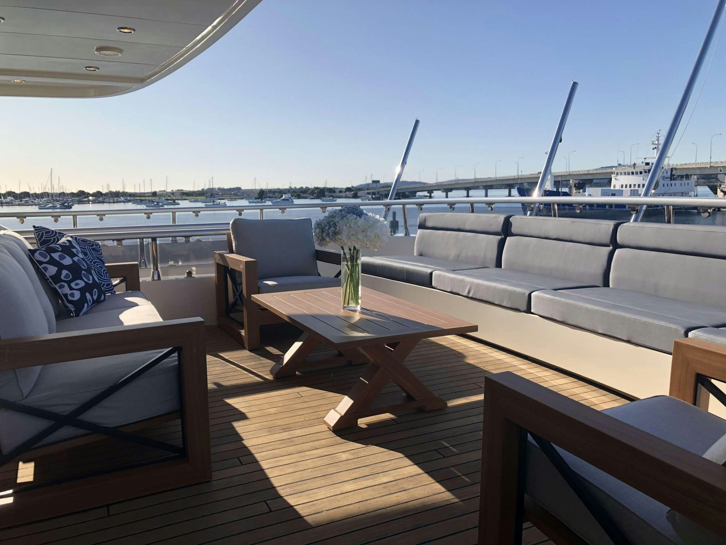 a room with a table and chairs aboard IRAMA Yacht for Charter