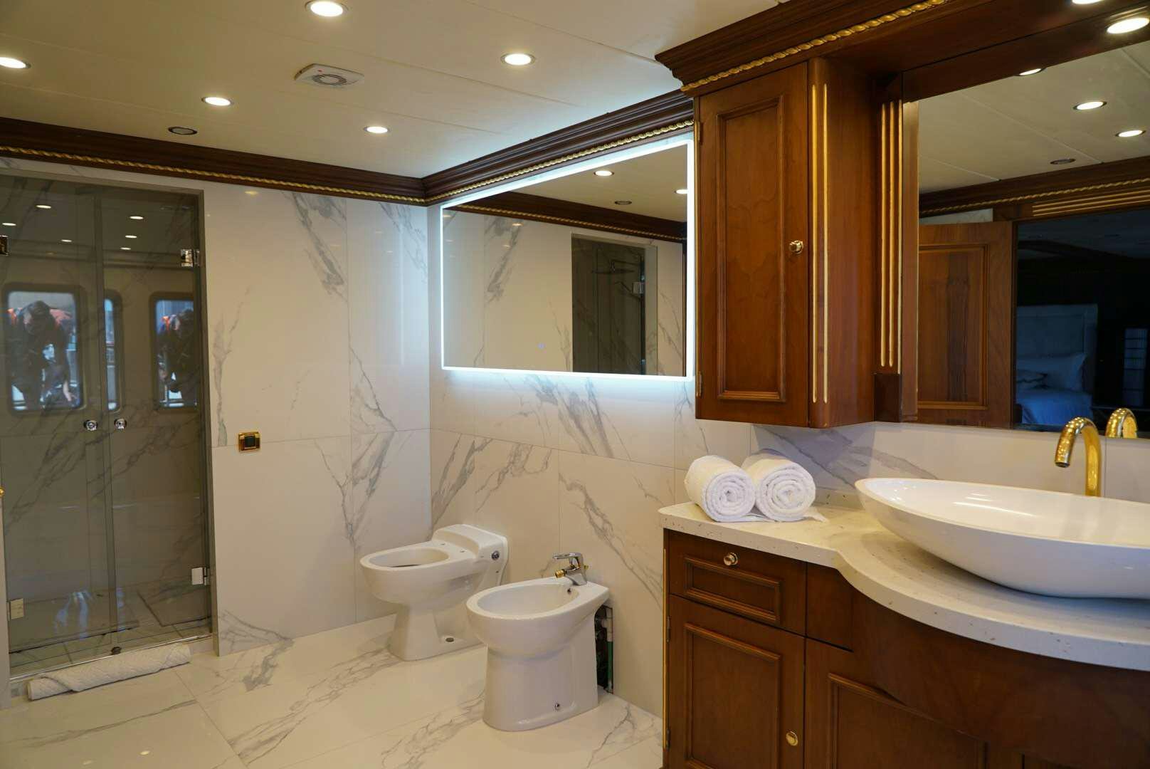 a bathroom with a sink toilet and a bathtub aboard IRAMA Yacht for Charter