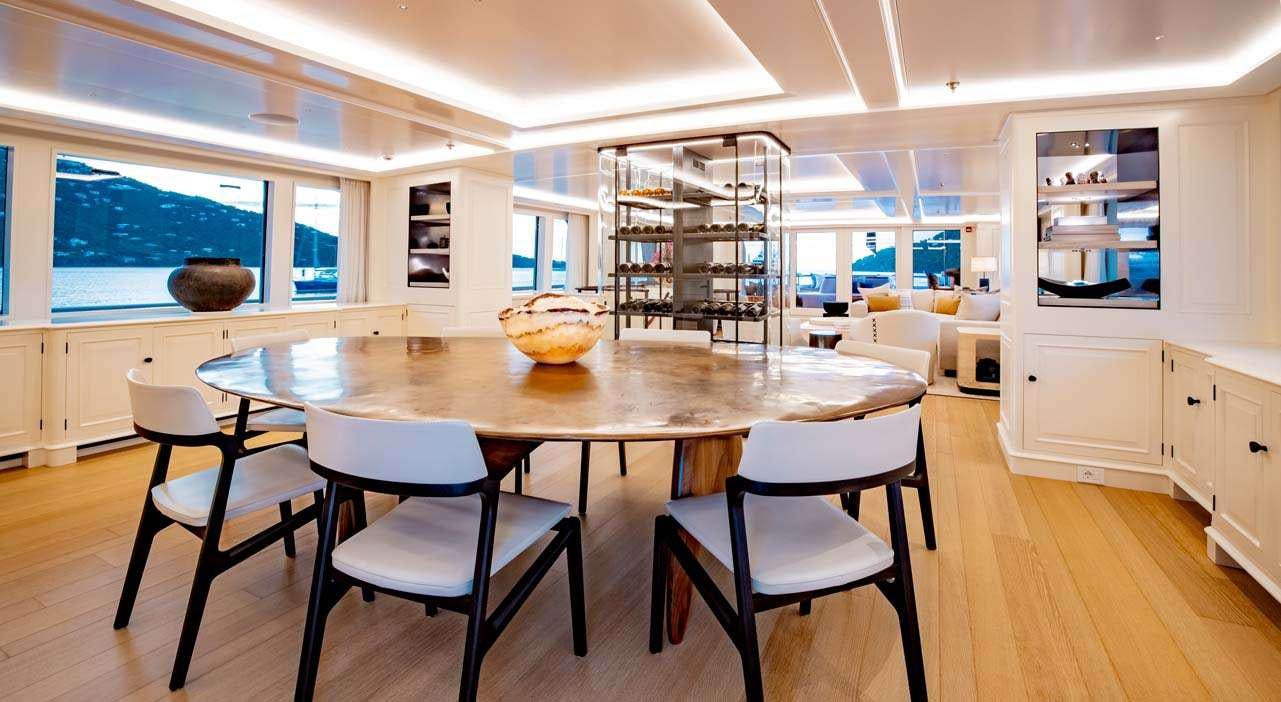 a kitchen with a table and chairs aboard BROADWATER Yacht for Charter