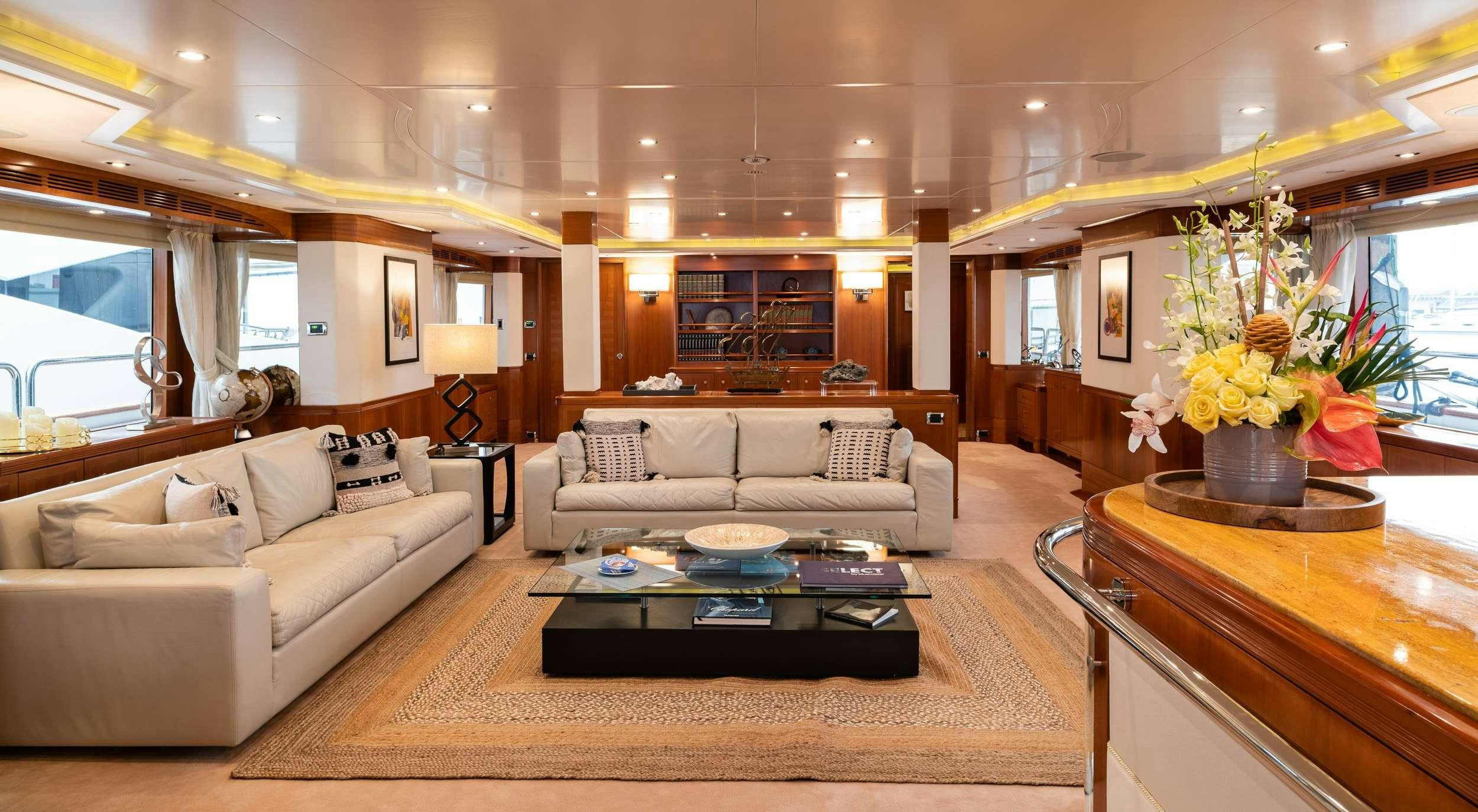 a living room with a couch and a coffee table aboard ALEGRIA Yacht for Charter
