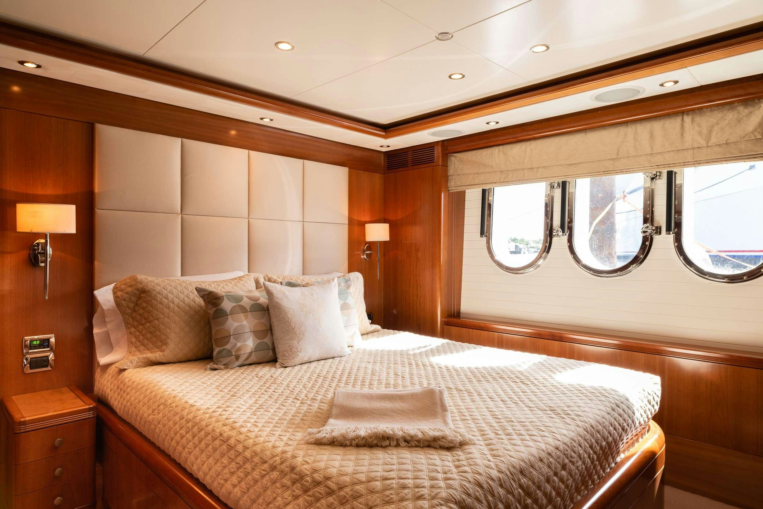 a bed with a white comforter aboard ALEGRIA Yacht for Charter