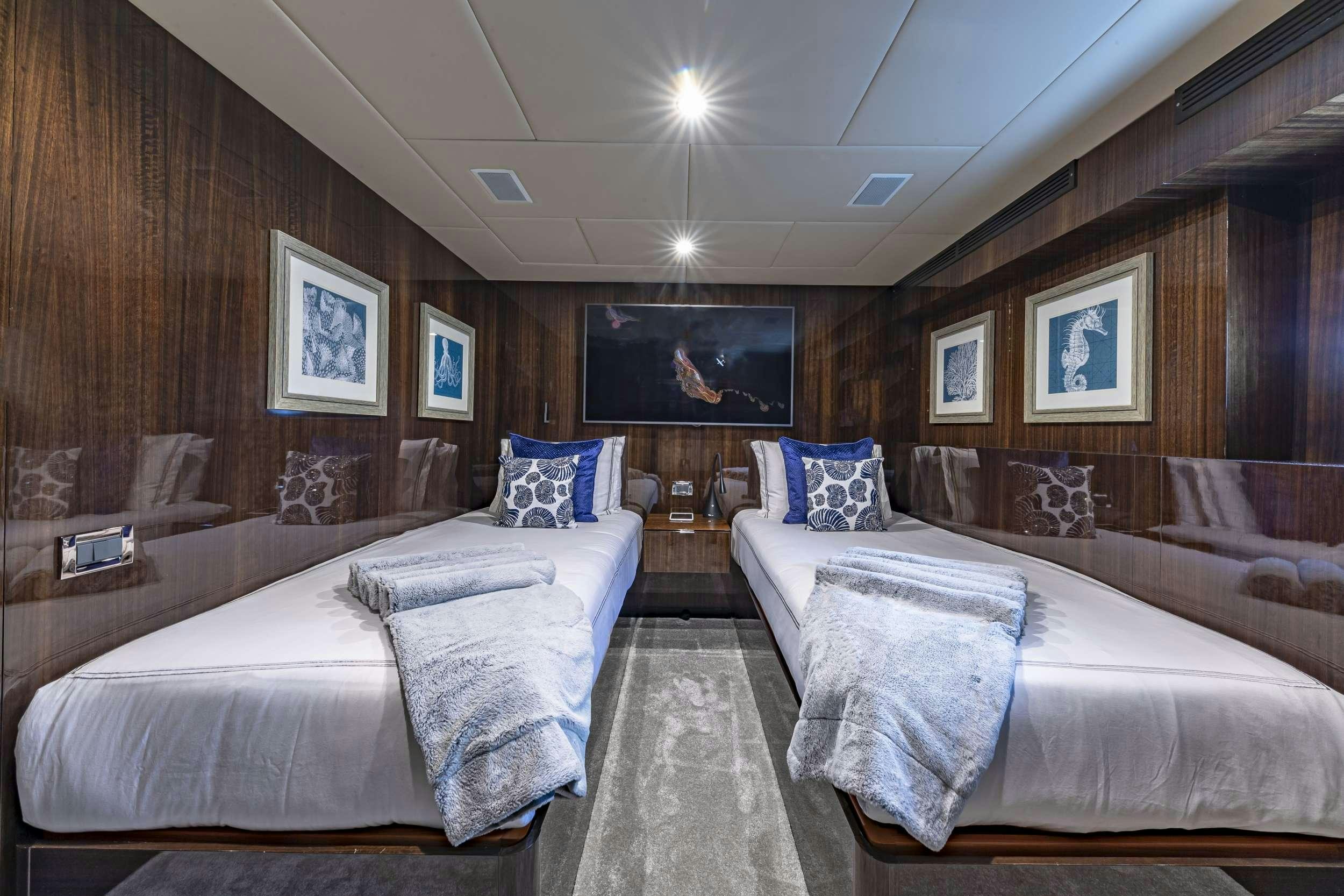 a room with two beds aboard OCULUS Yacht for Charter