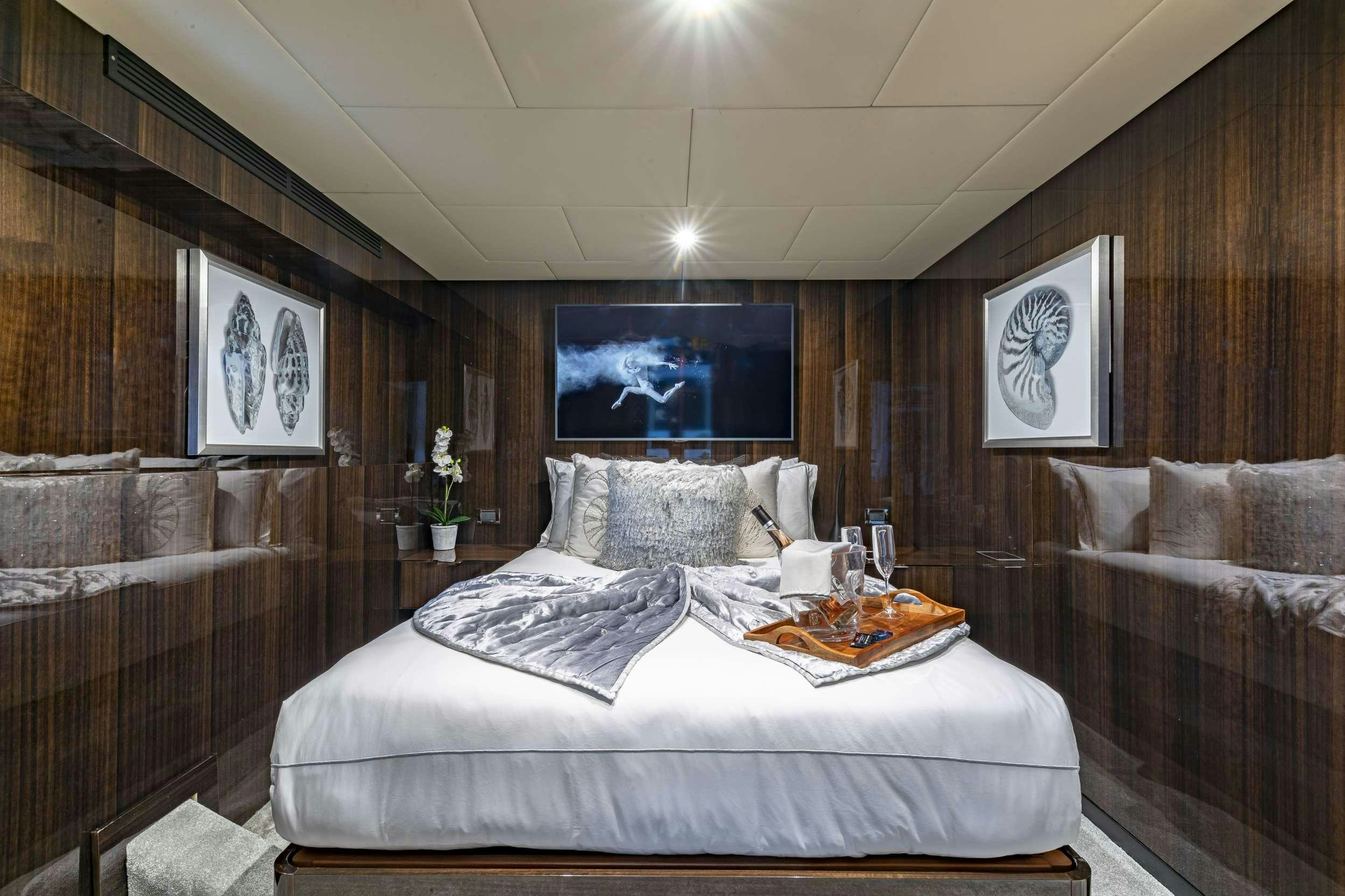 a room with a couch and a television aboard OCULUS Yacht for Charter