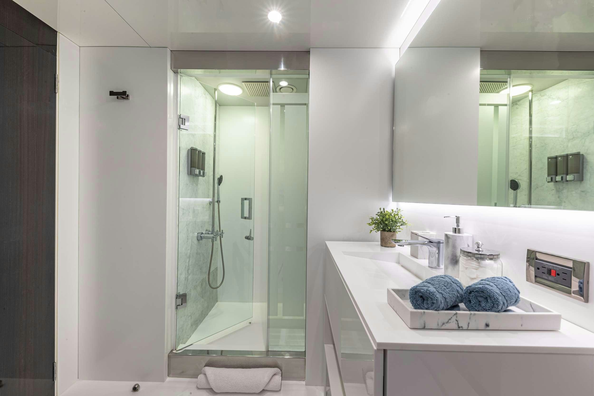 a bathroom with a glass shower aboard OCULUS Yacht for Charter