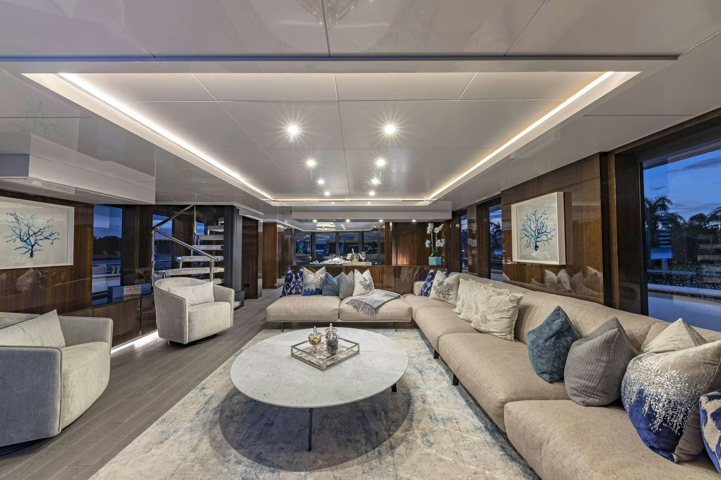 a living room with a large window aboard OCULUS Yacht for Charter