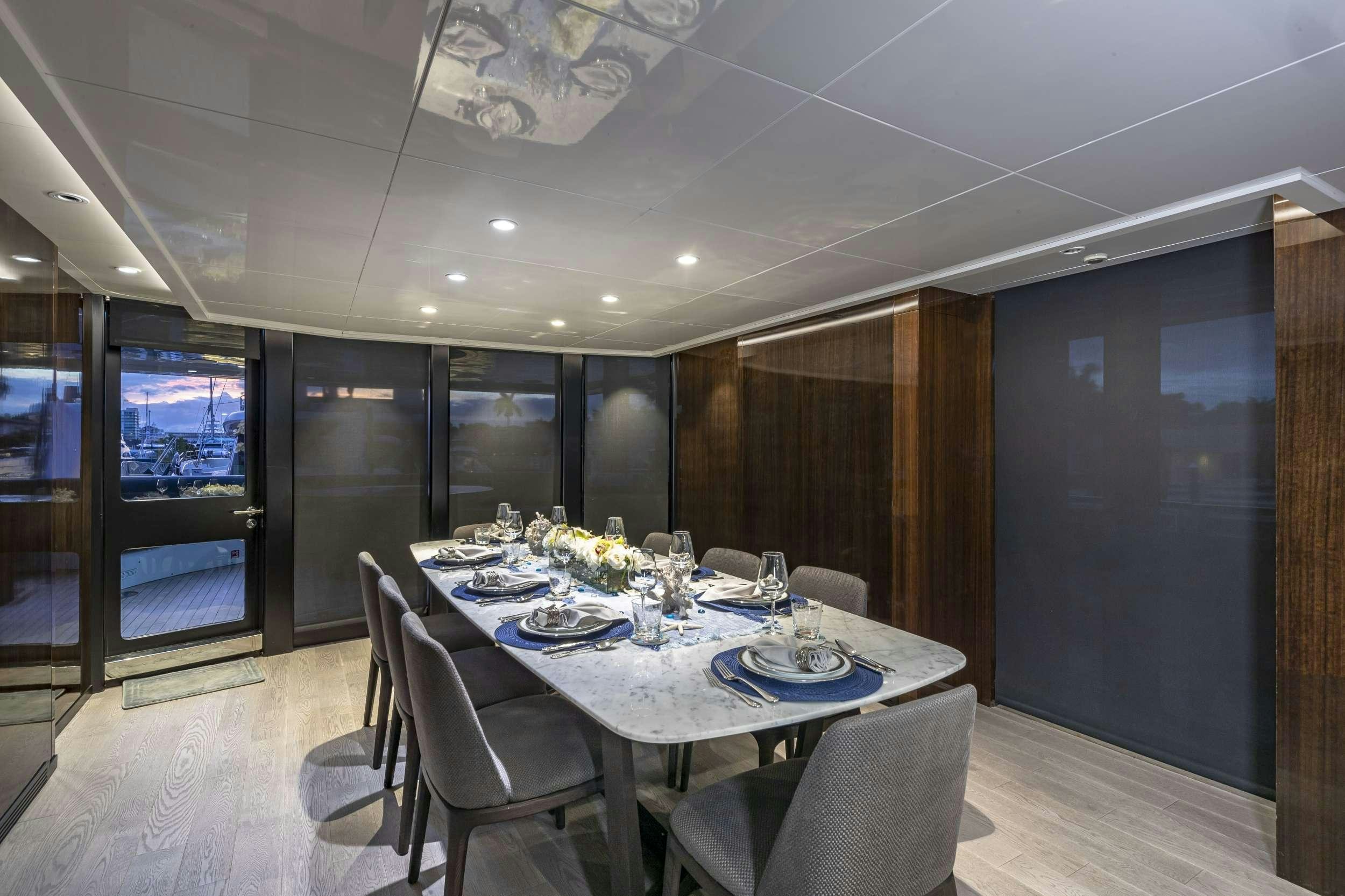 a dining room with a table and chairs aboard OCULUS Yacht for Charter