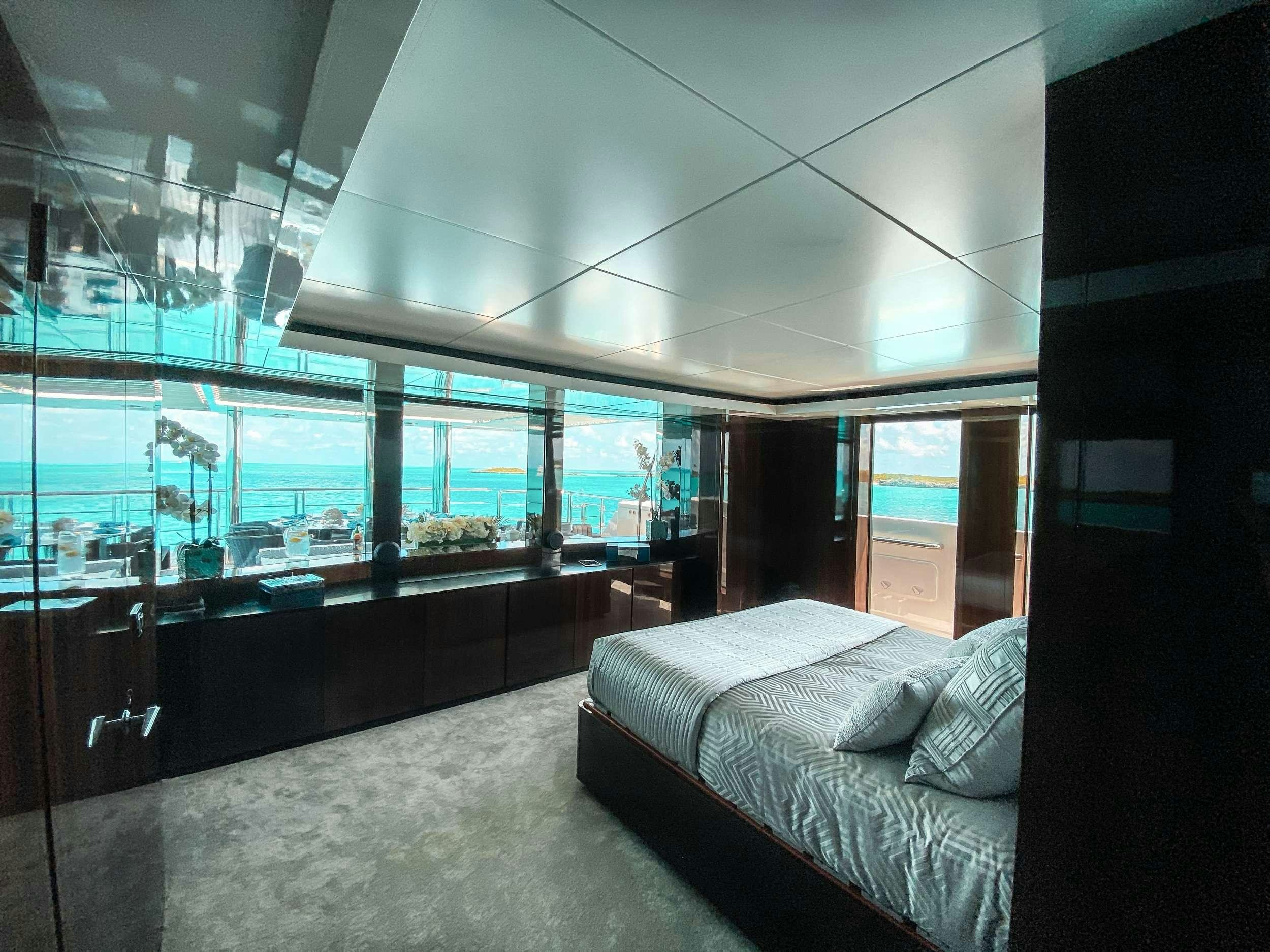a room with a bed and a window aboard OCULUS Yacht for Charter