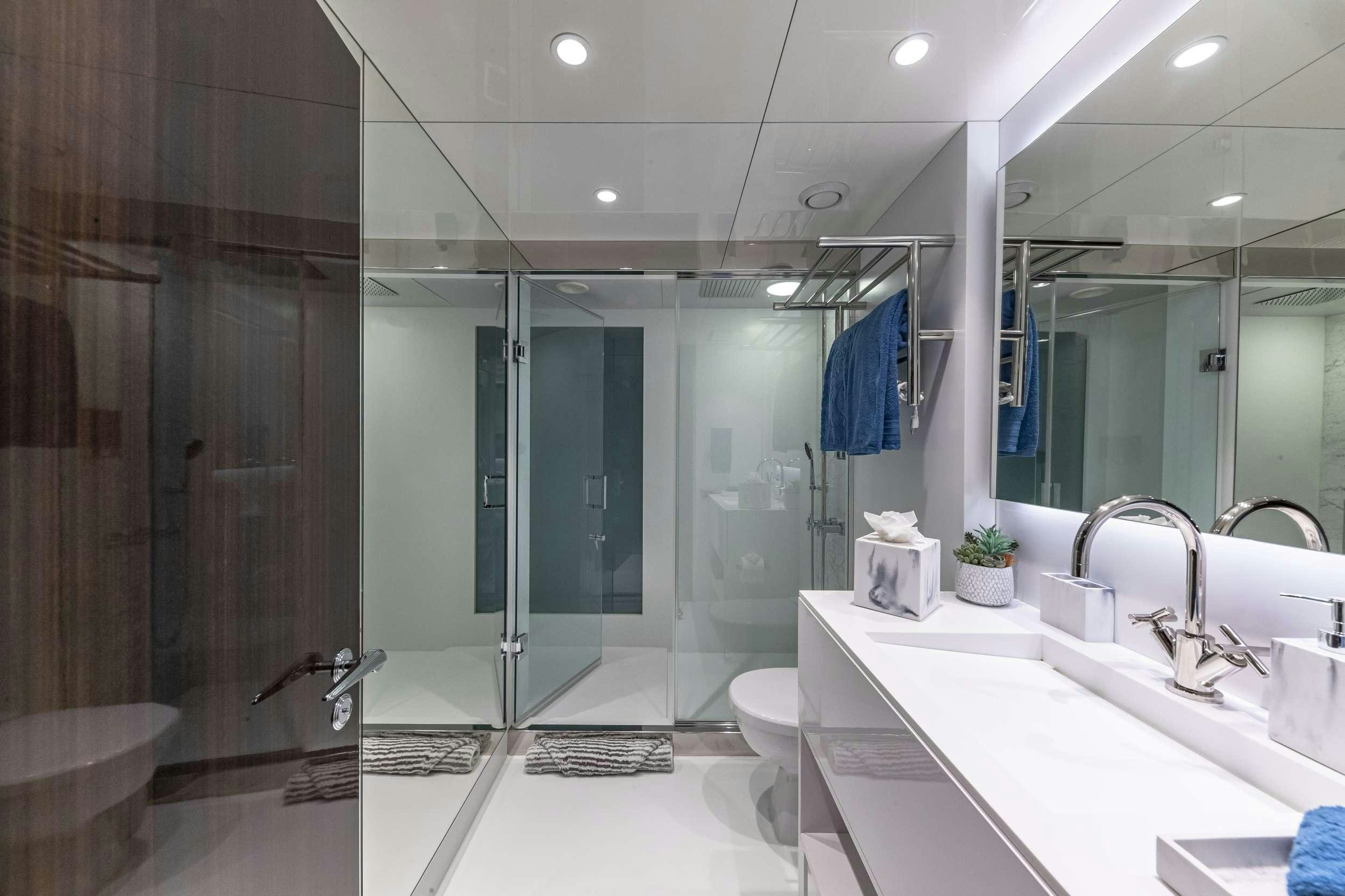 a bathroom with a glass shower aboard OCULUS Yacht for Charter