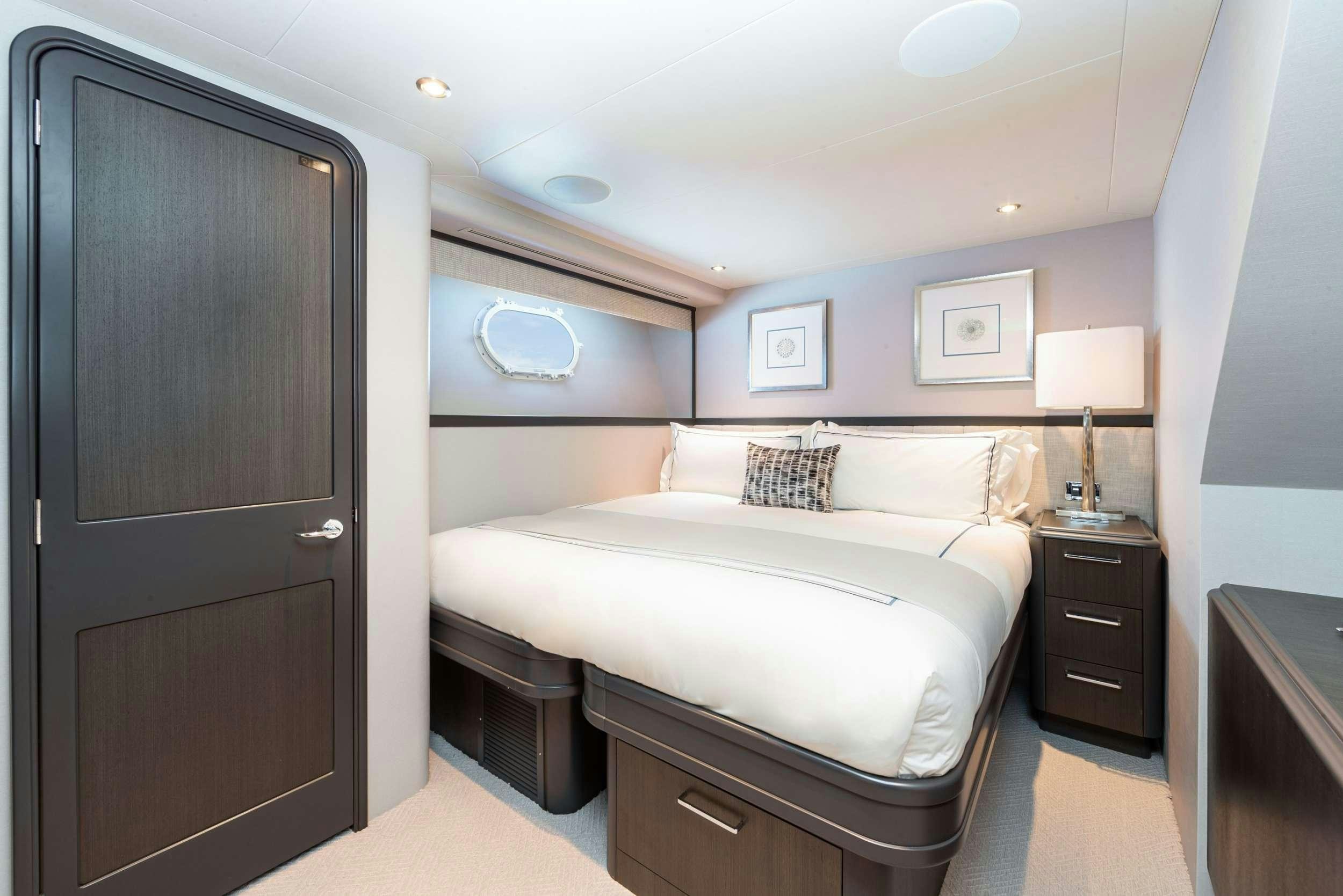 a bedroom with a bed and a closet aboard NO BAD IDEAS Yacht for Charter