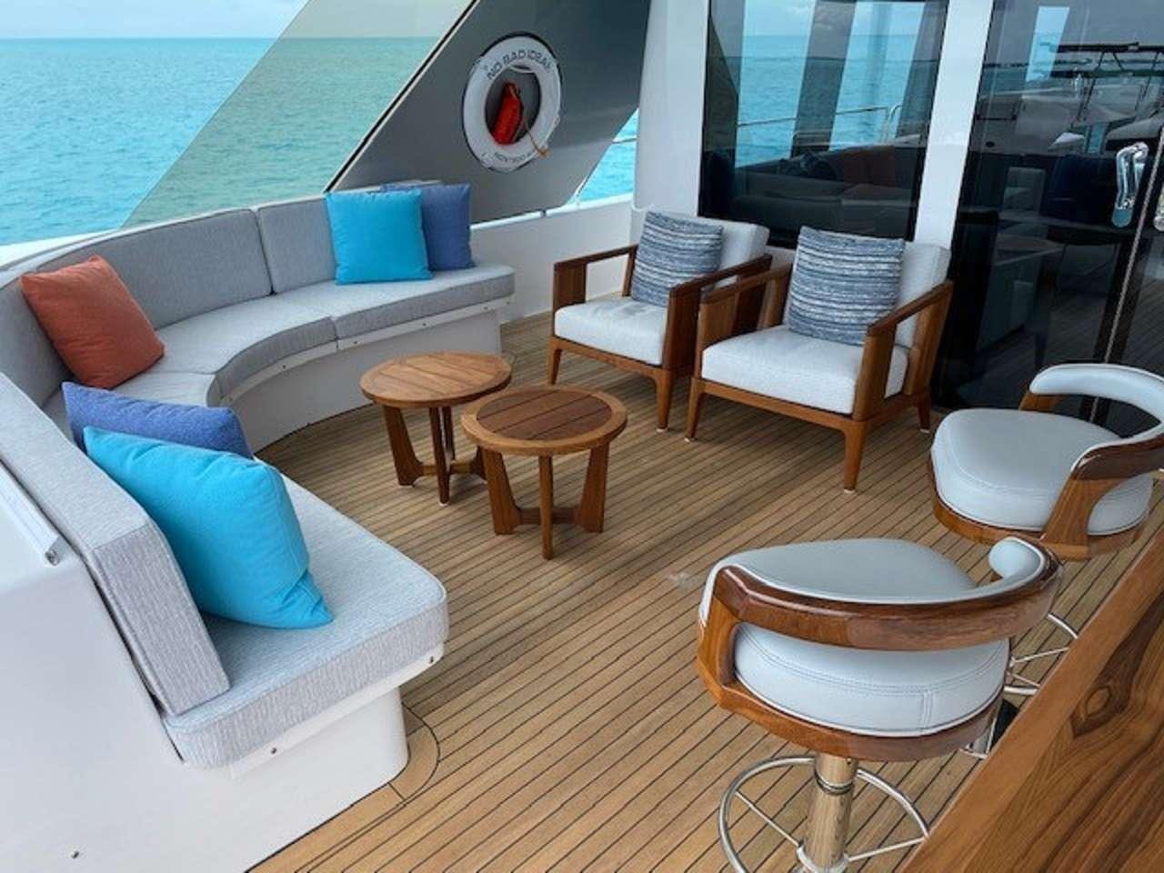 a room with a couch and chairs aboard NO BAD IDEAS Yacht for Charter