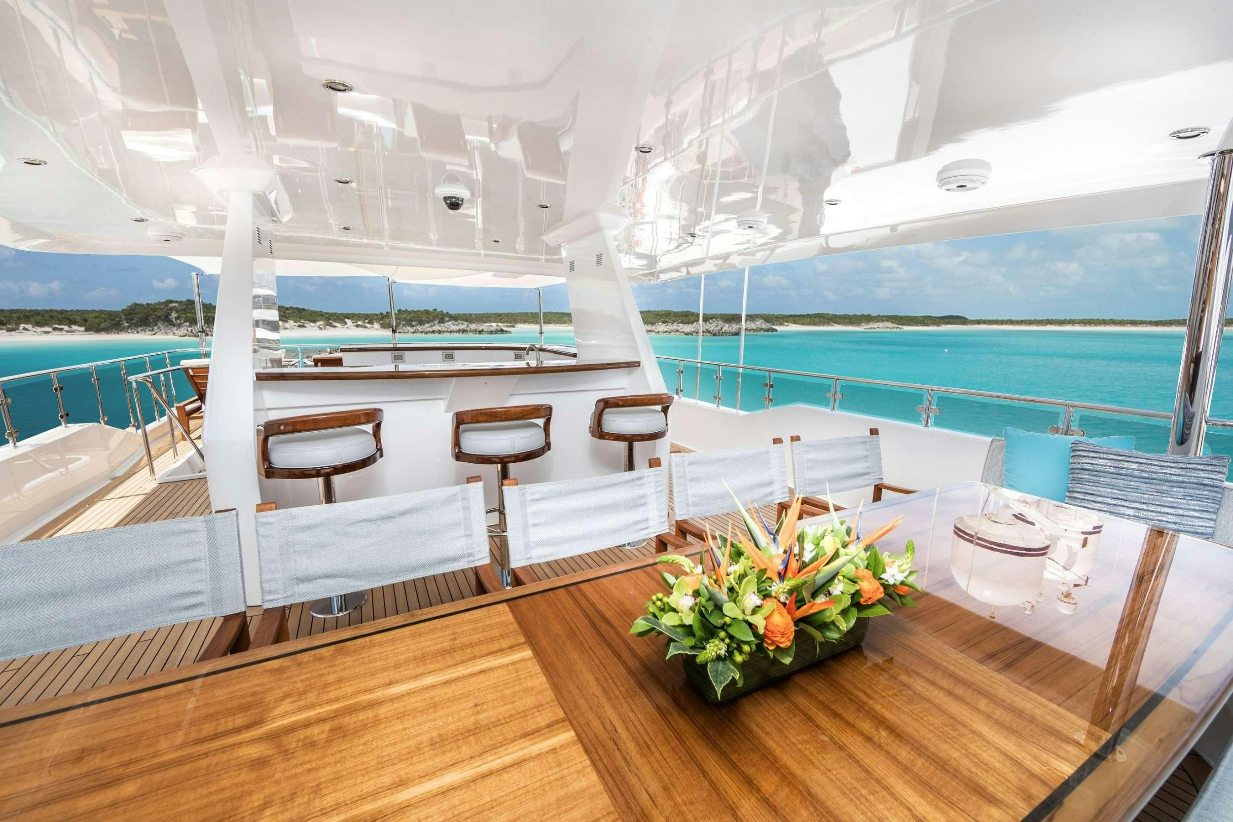 a room with a table and chairs aboard NO BAD IDEAS Yacht for Charter