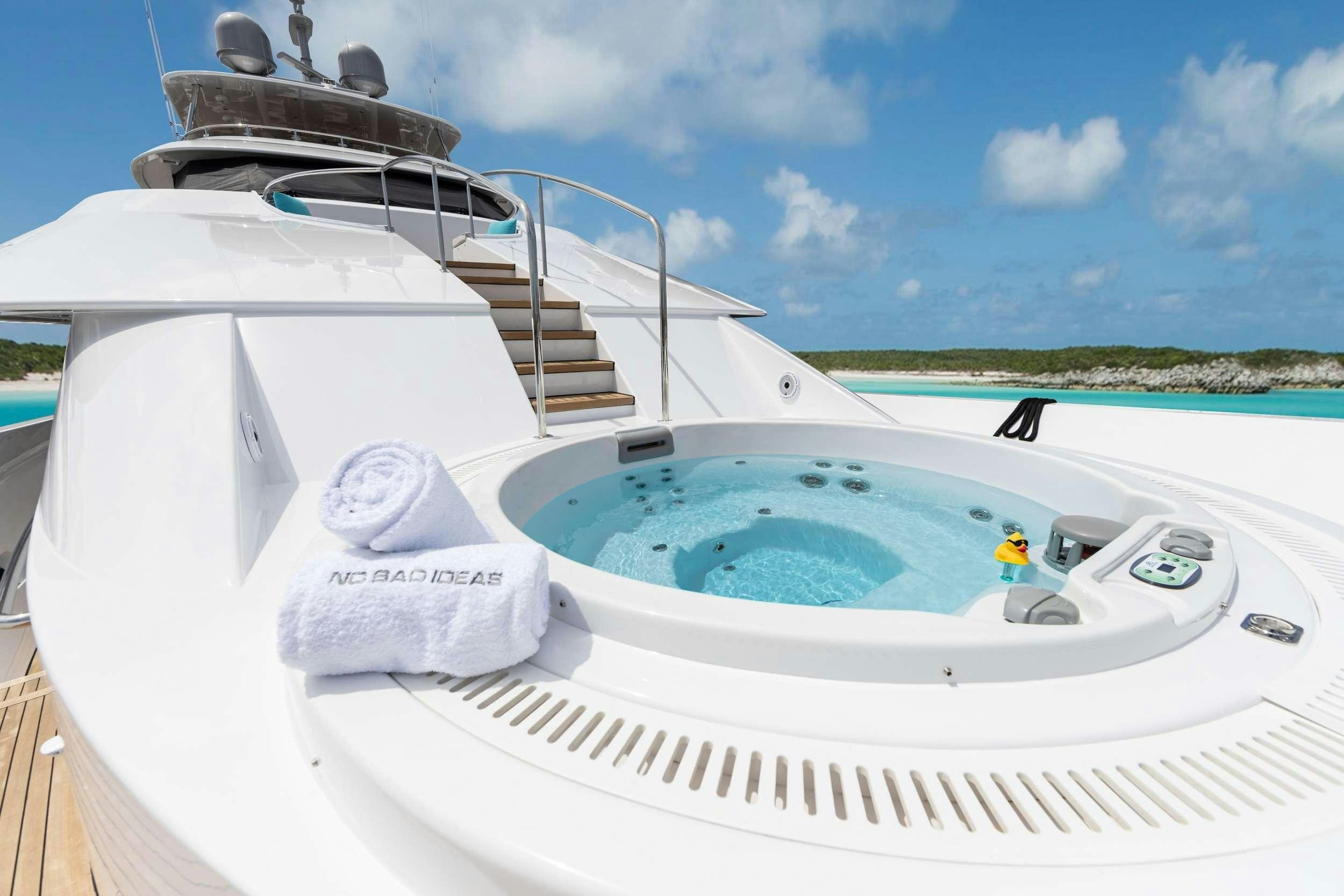 a white boat with a white cover and a white float on it aboard NO BAD IDEAS Yacht for Charter