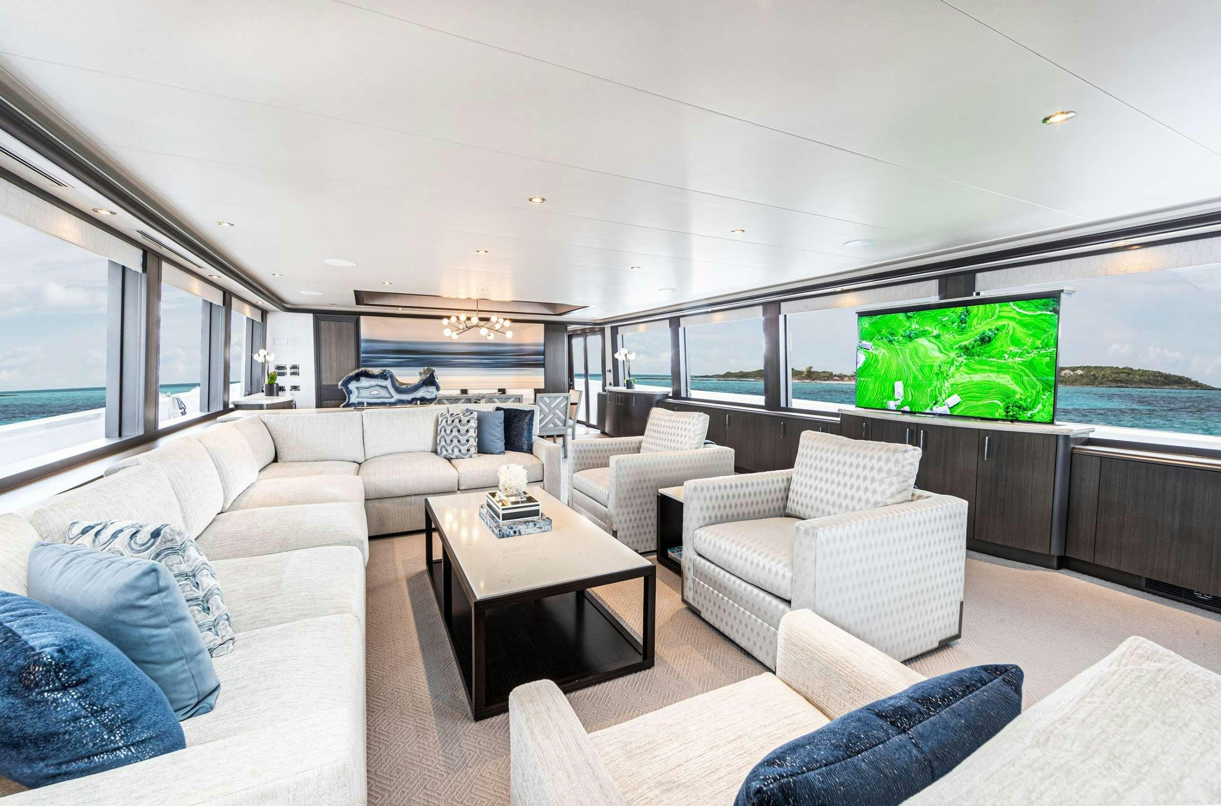 a living room with a large screen aboard NO BAD IDEAS Yacht for Charter