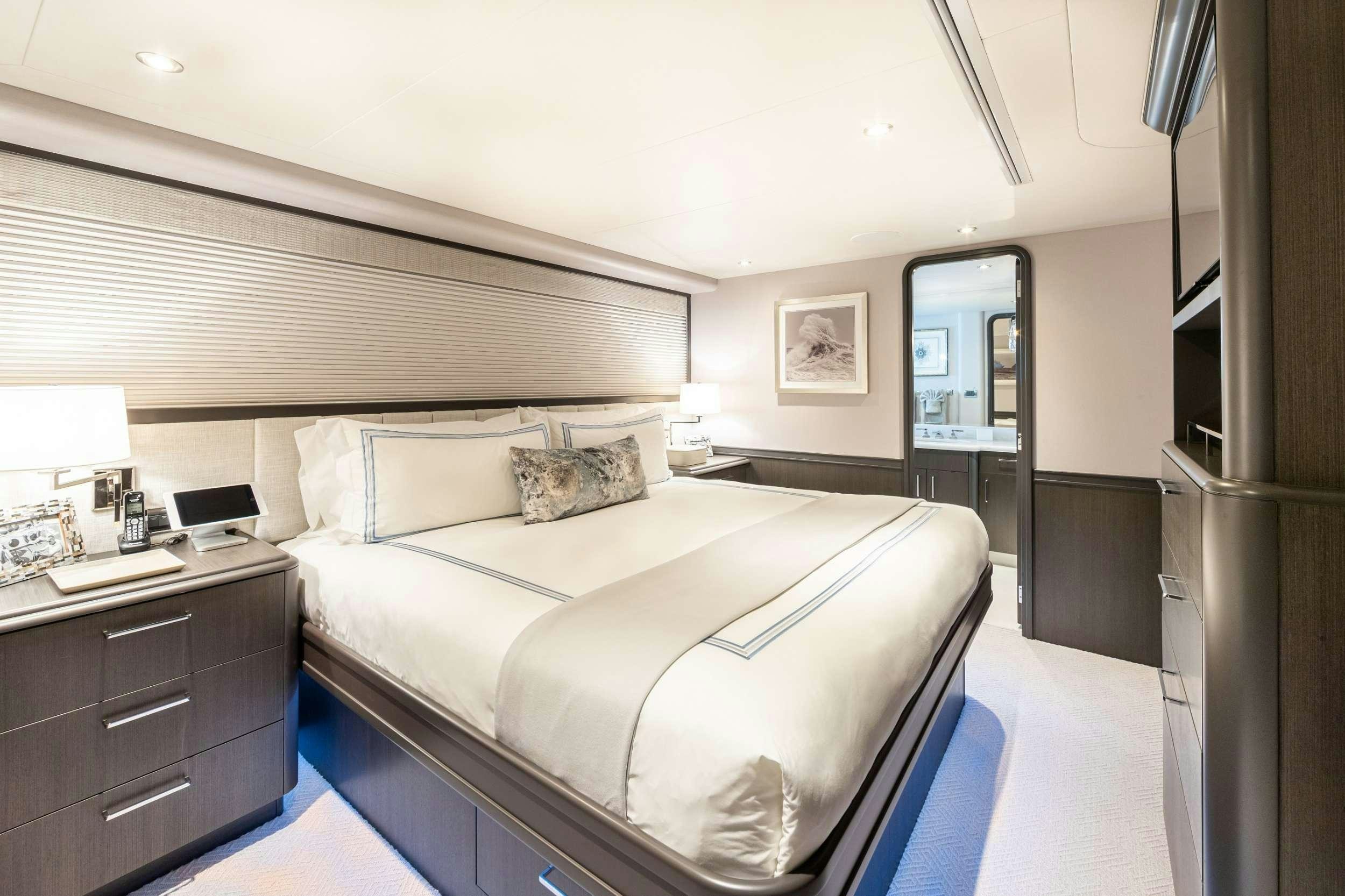 a bedroom with a bed and a desk aboard NO BAD IDEAS Yacht for Charter