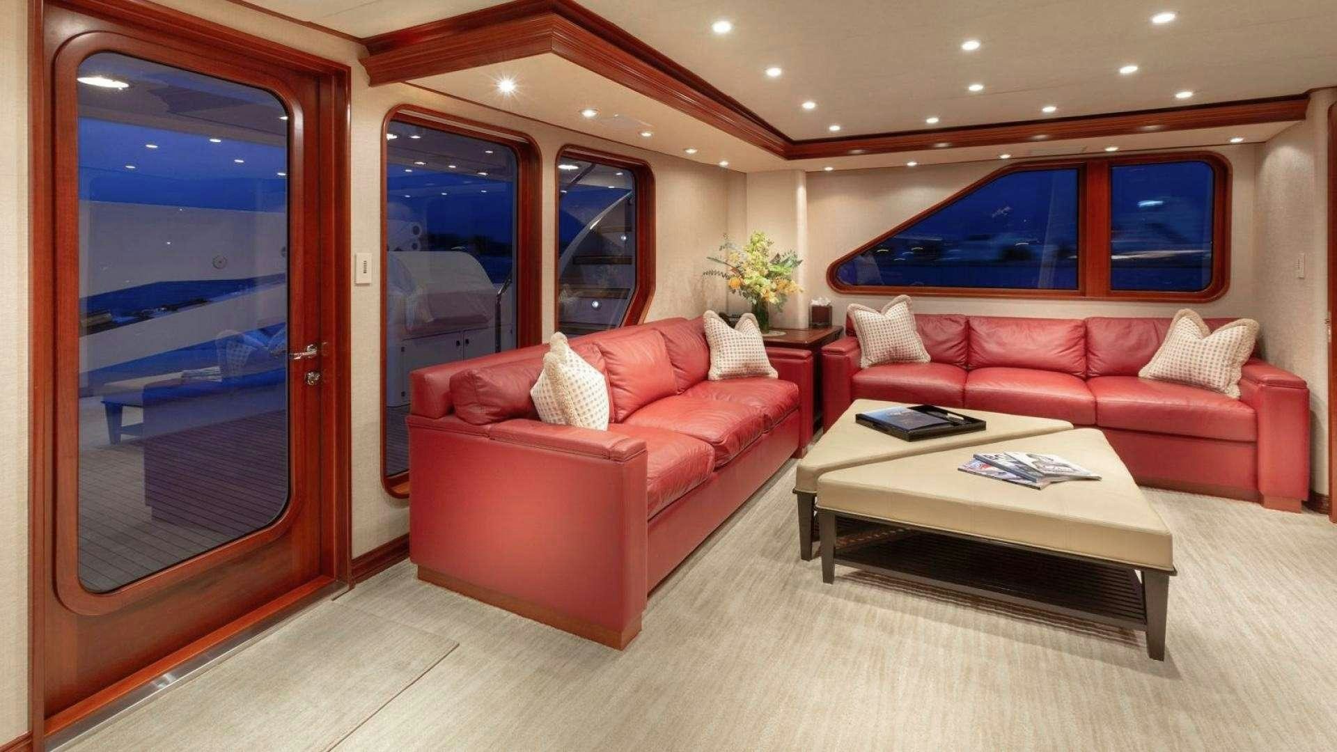 a living room with a red couch aboard IMPETUOUS Yacht for Charter