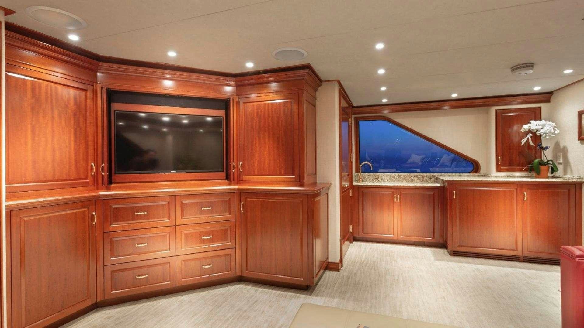 a room with wooden cabinets aboard IMPETUOUS Yacht for Charter