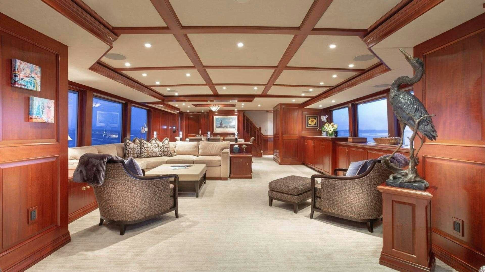 a room with a couch and a tv aboard IMPETUOUS Yacht for Charter