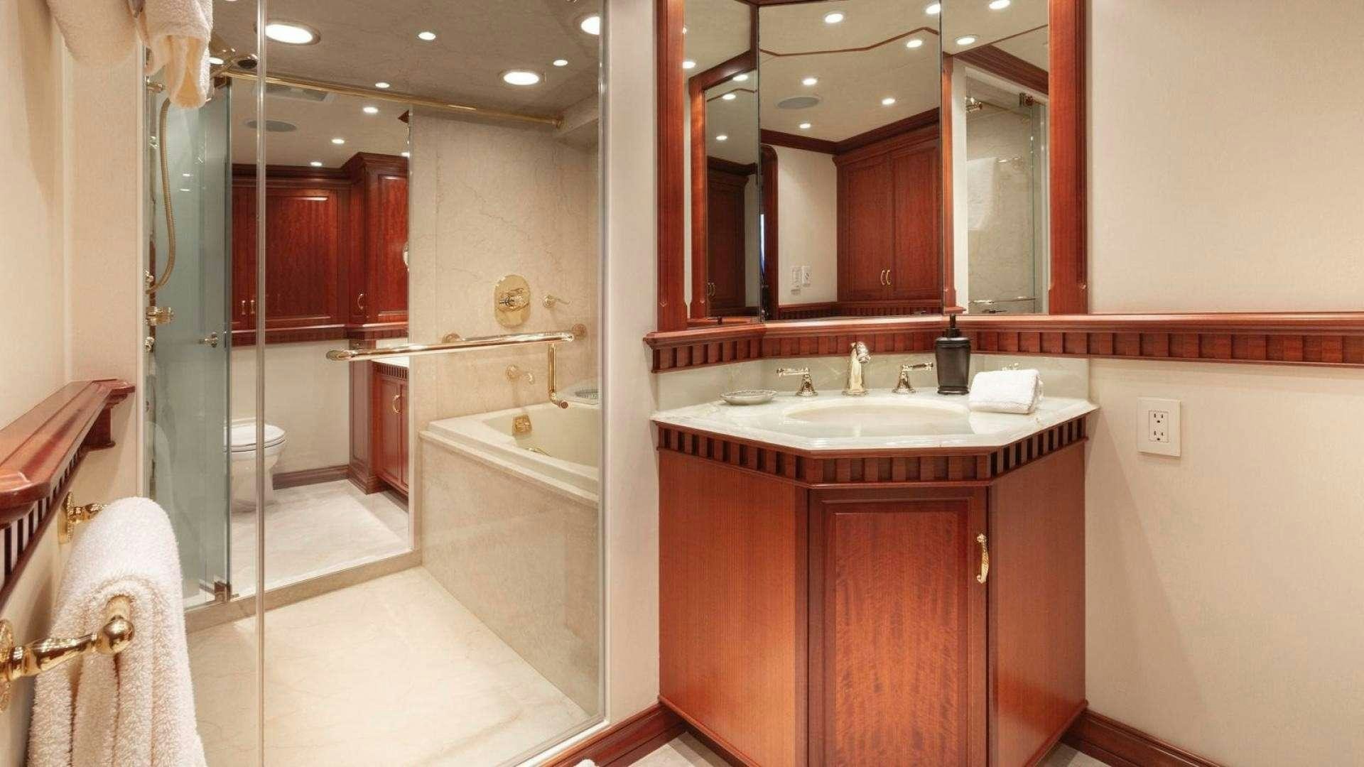 a bathroom with a sink and a bathtub aboard IMPETUOUS Yacht for Charter