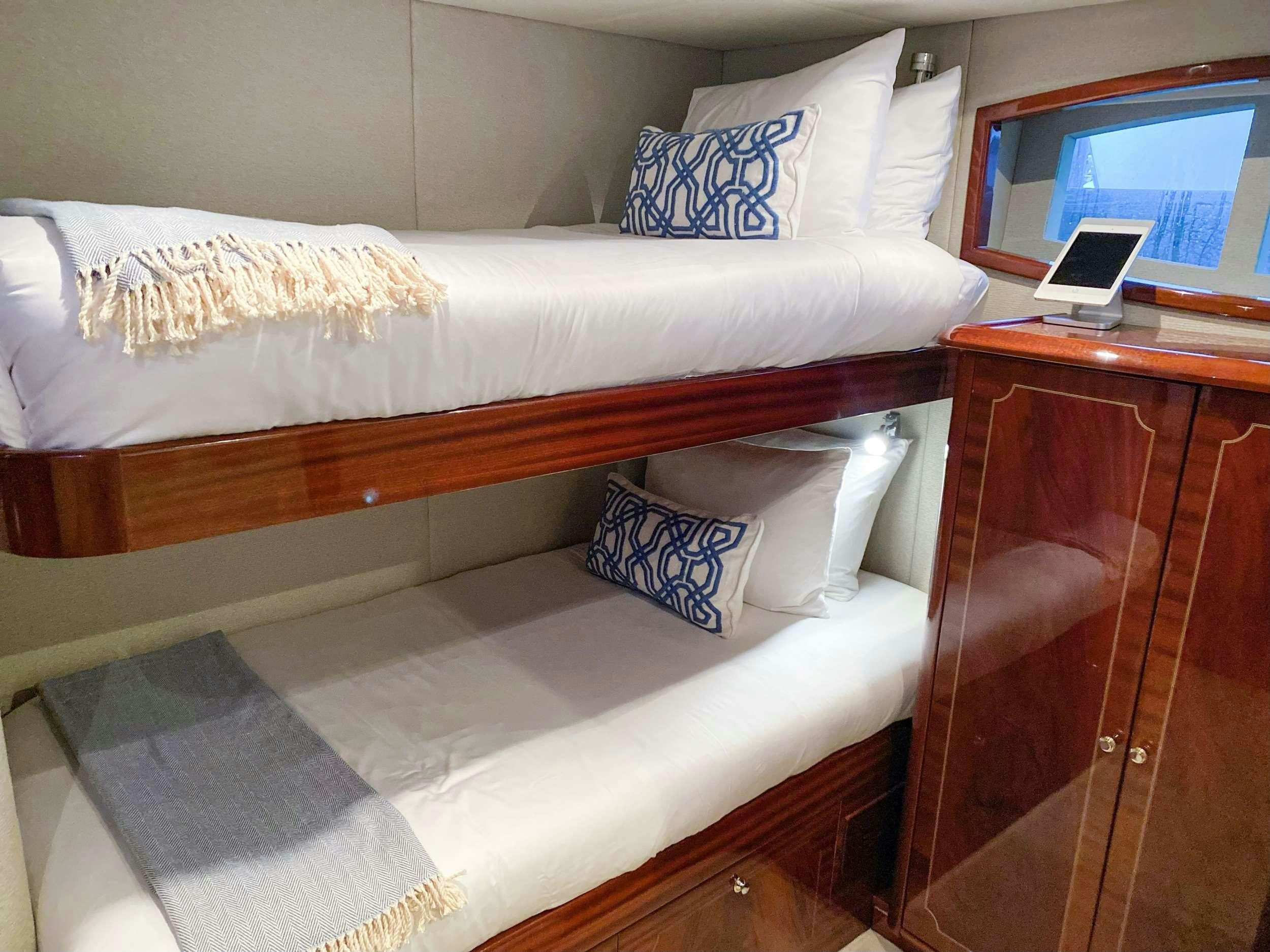a bed with a laptop on it aboard NAMASTAY Yacht for Charter
