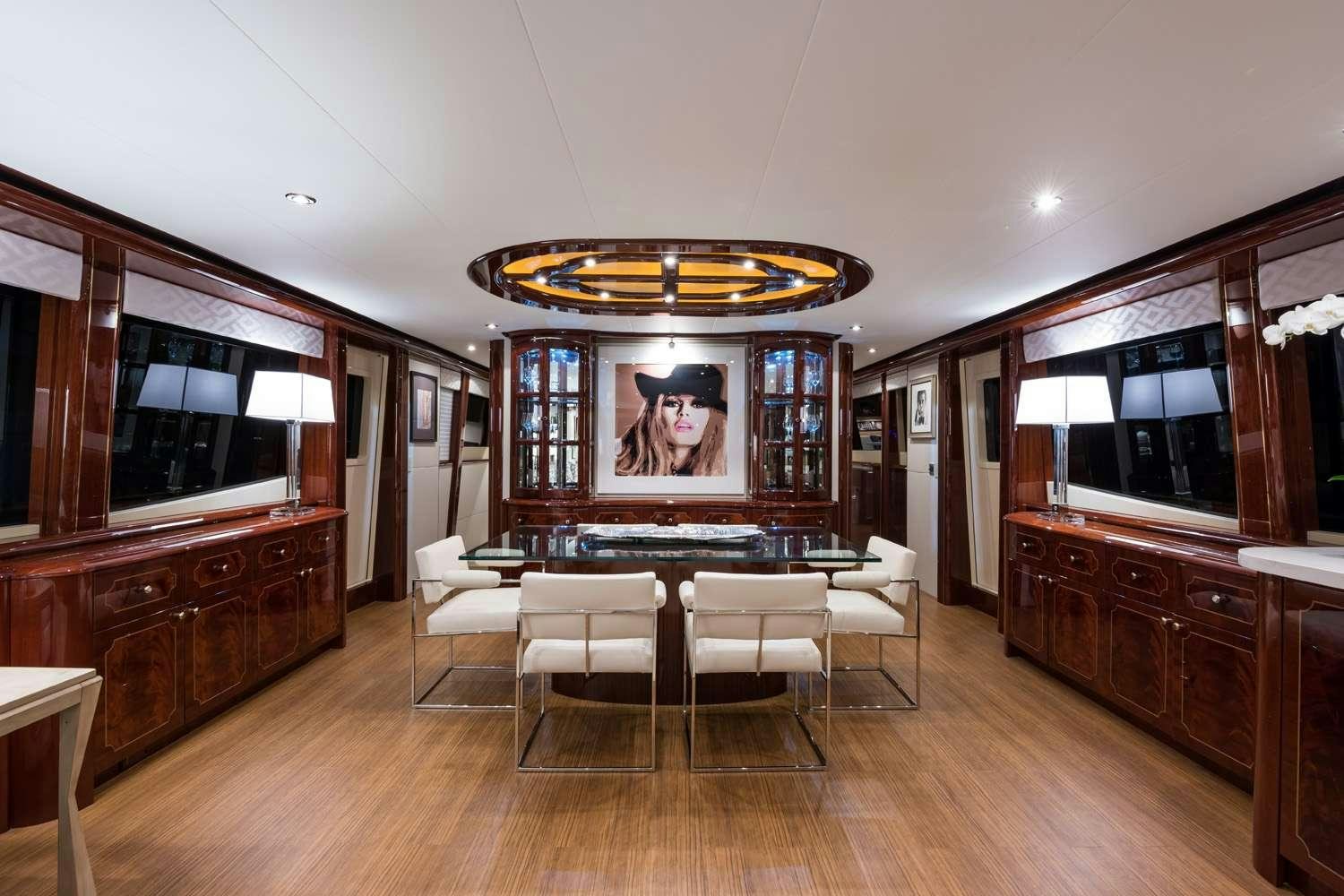 a large room with a table and chairs aboard QTR Yacht for Charter