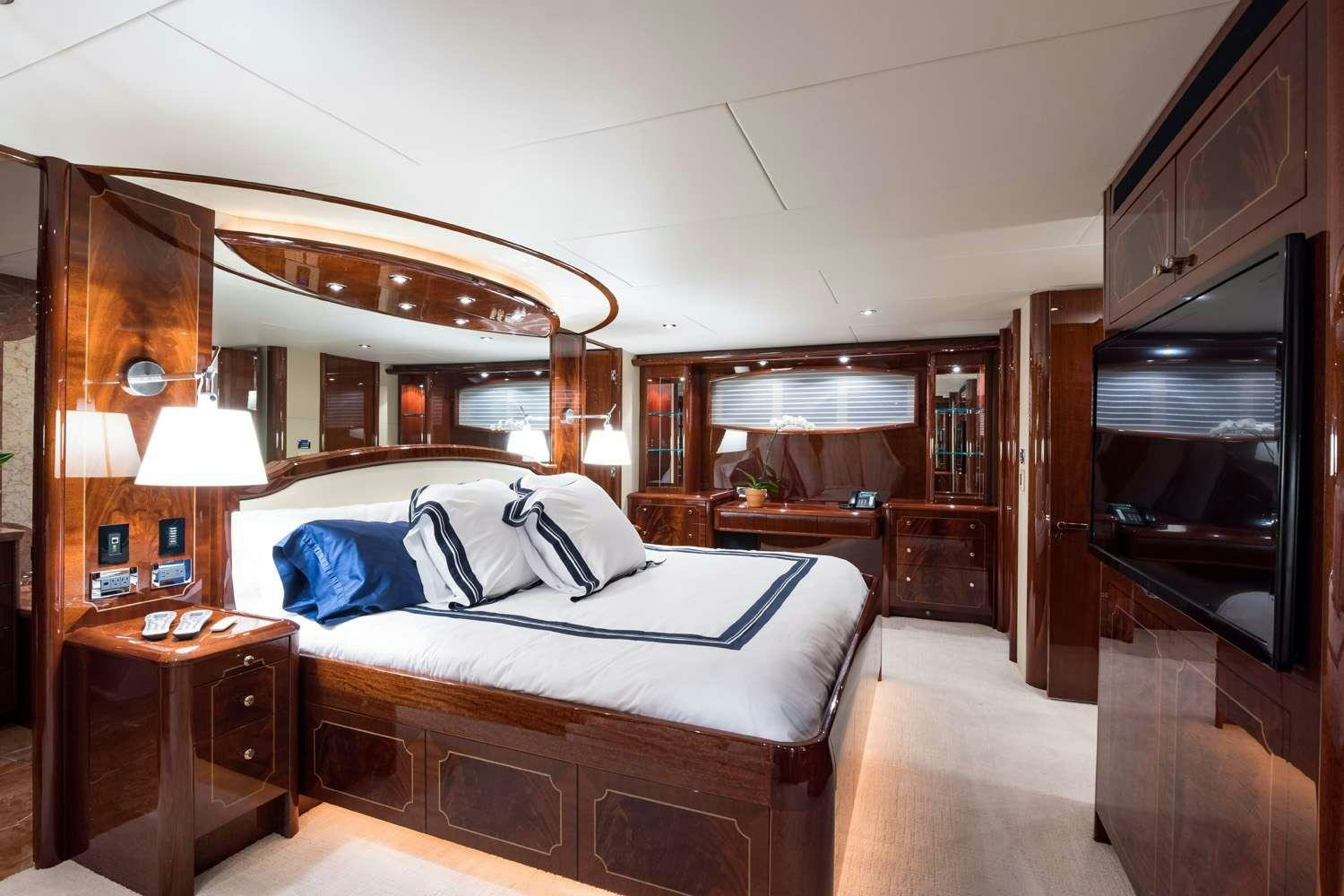 a bedroom with a bed and a fireplace aboard QTR Yacht for Charter