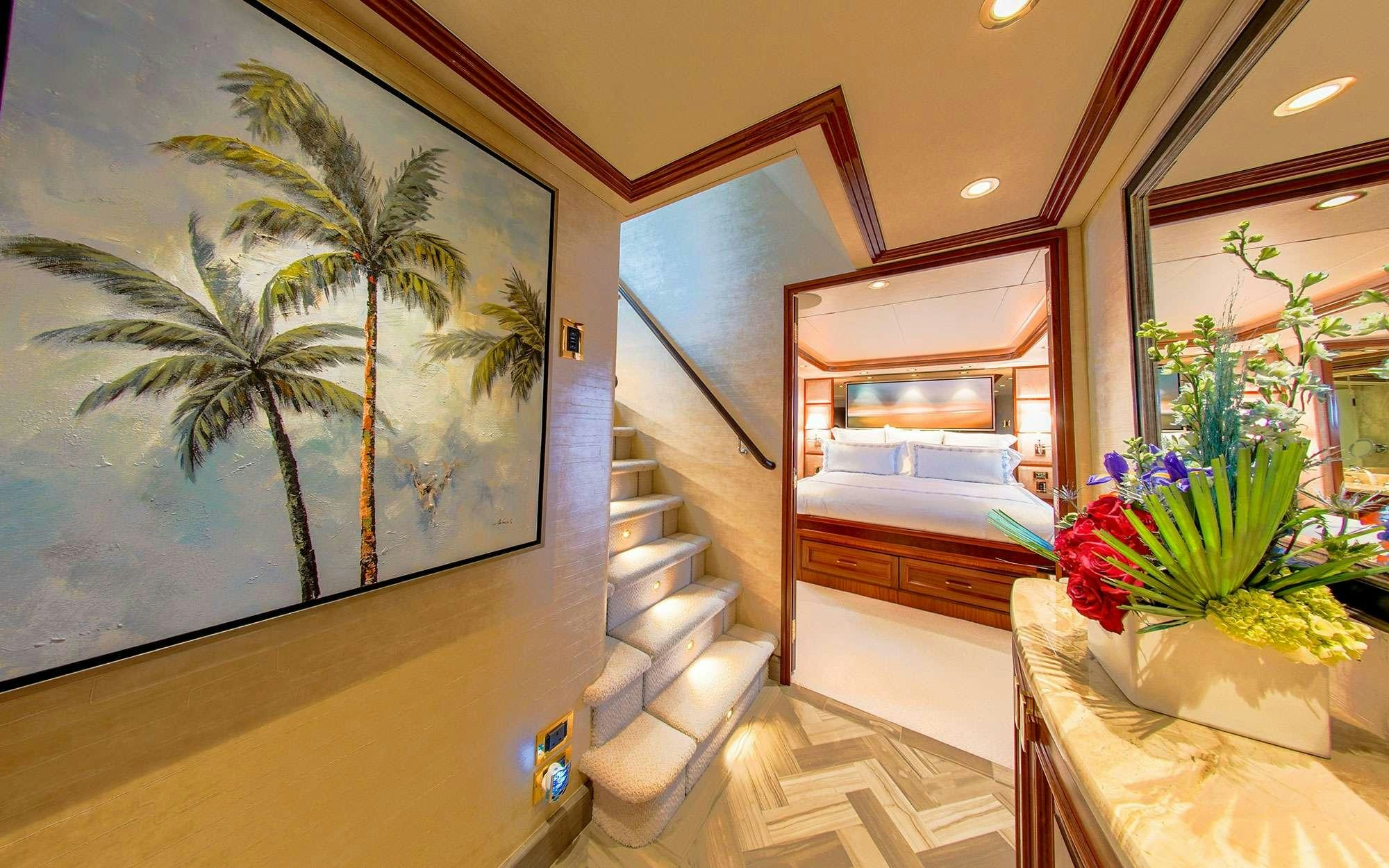 a room with a staircase and potted plants aboard JEANNIETINI Yacht for Charter
