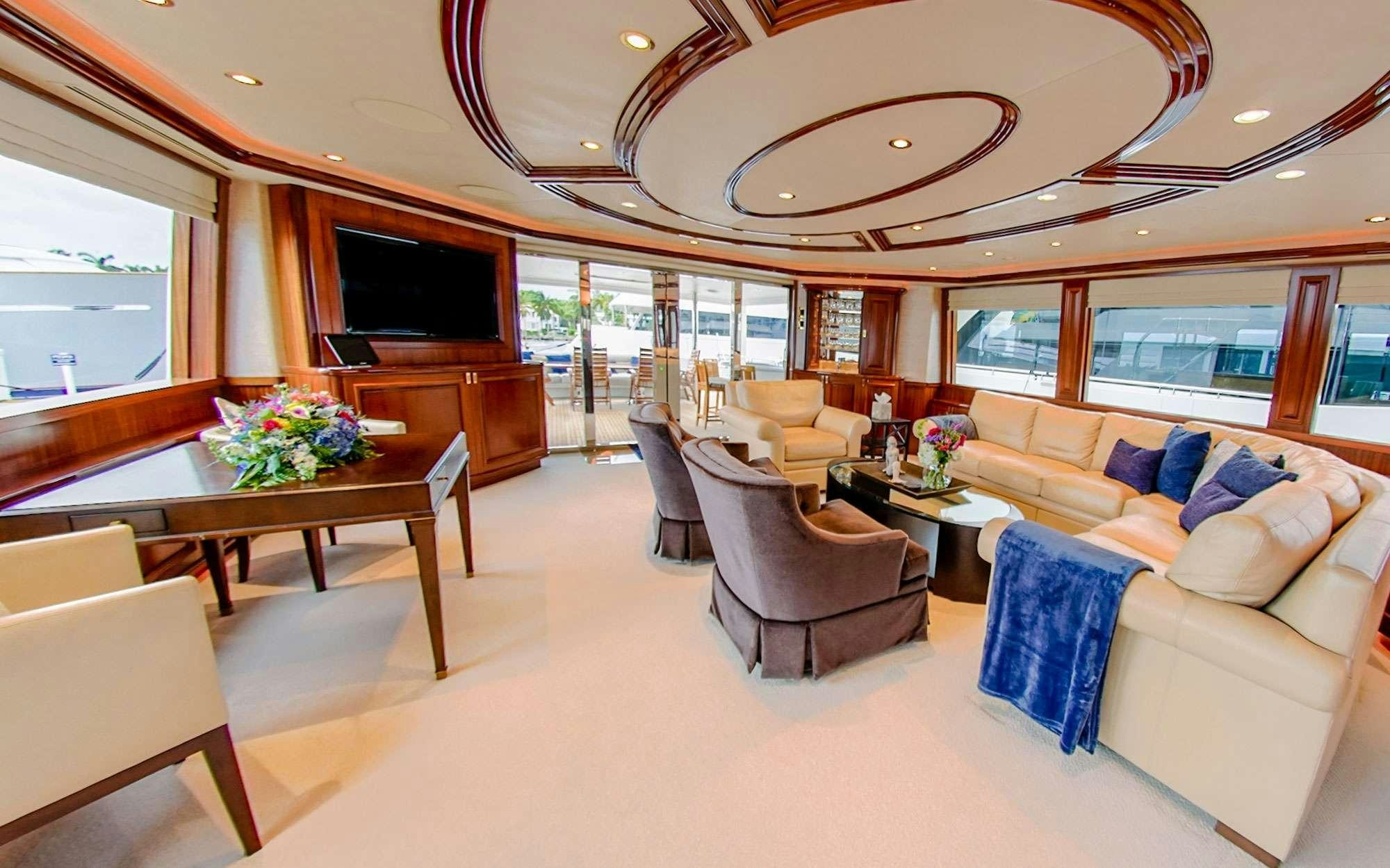a living room with a large window aboard JEANNIETINI Yacht for Charter