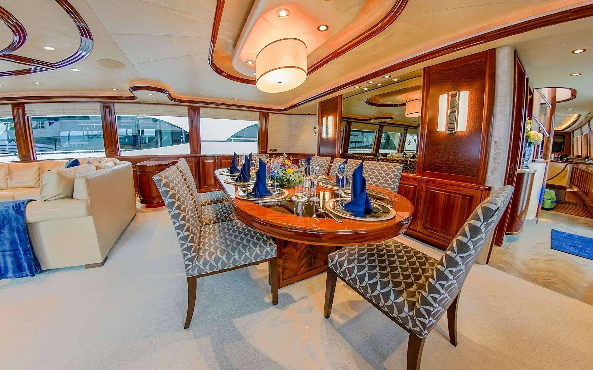 a dining room with a table and chairs aboard JEANNIETINI Yacht for Charter