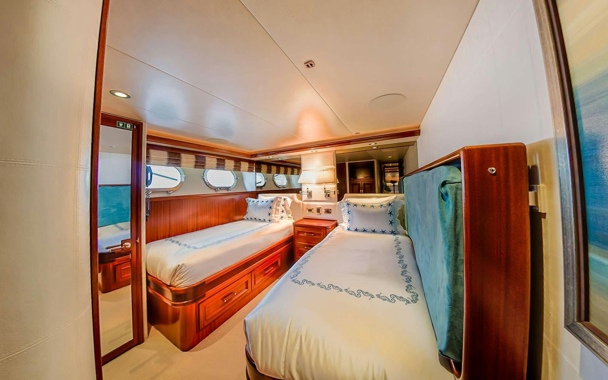 a room with a couple of beds aboard JEANNIETINI Yacht for Charter