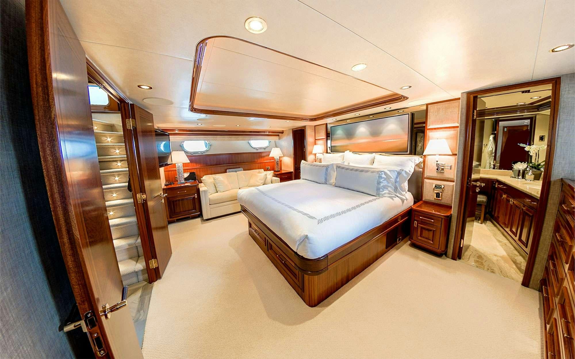 a bedroom with a bed and a mirror aboard JEANNIETINI Yacht for Charter