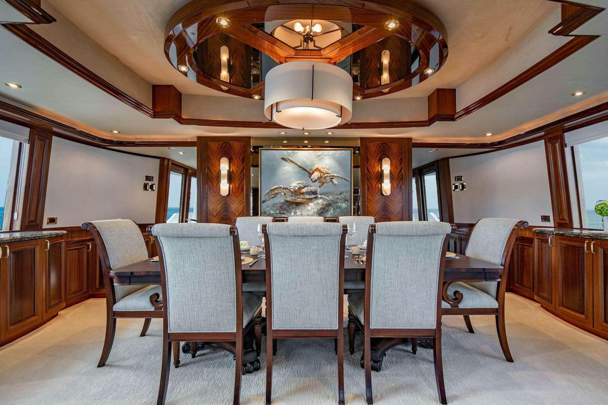 a large dining table with chairs around it aboard NOW OR NEVER Yacht for Charter