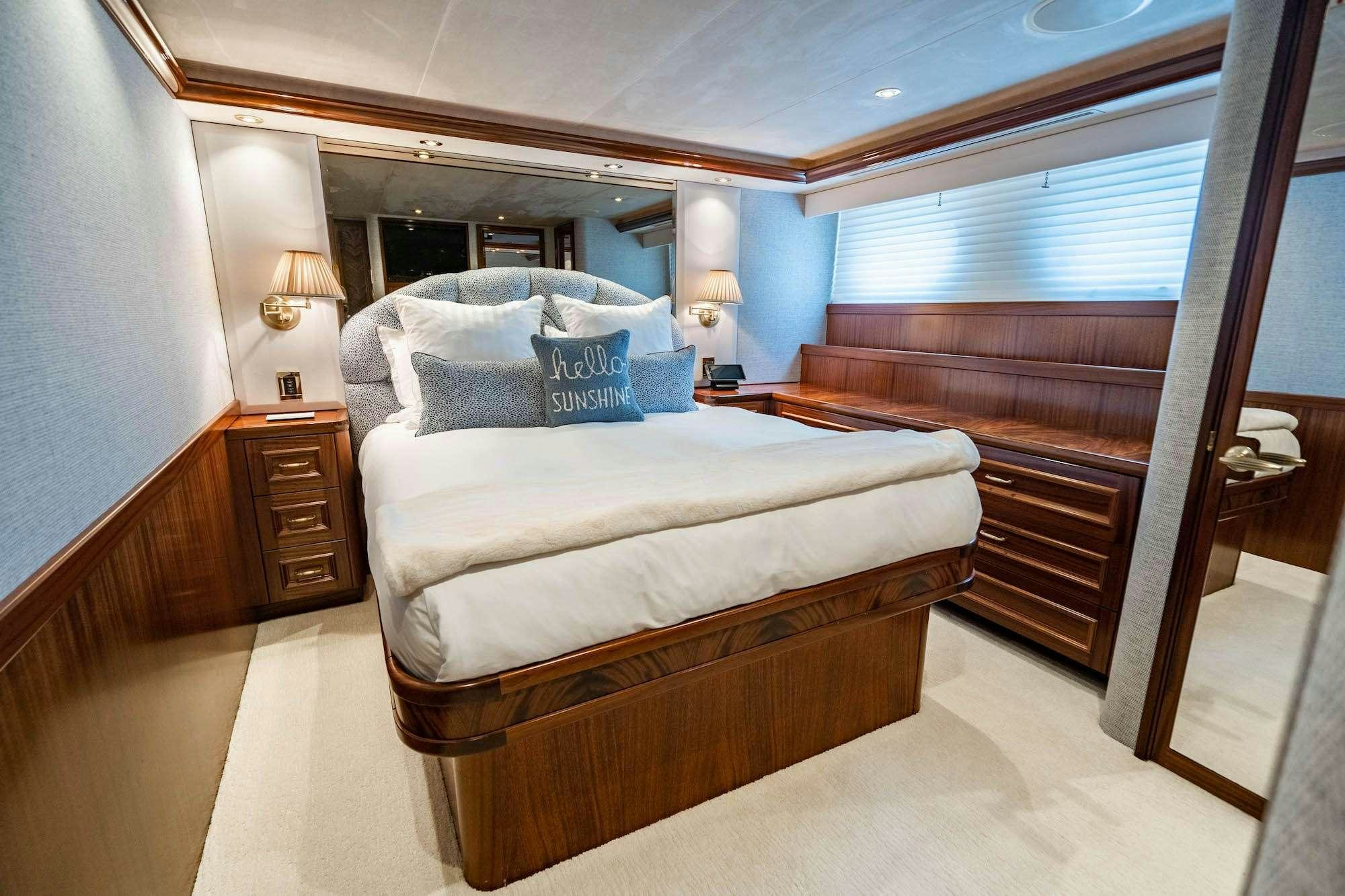 a bedroom with a bed and a desk aboard NOW OR NEVER Yacht for Charter