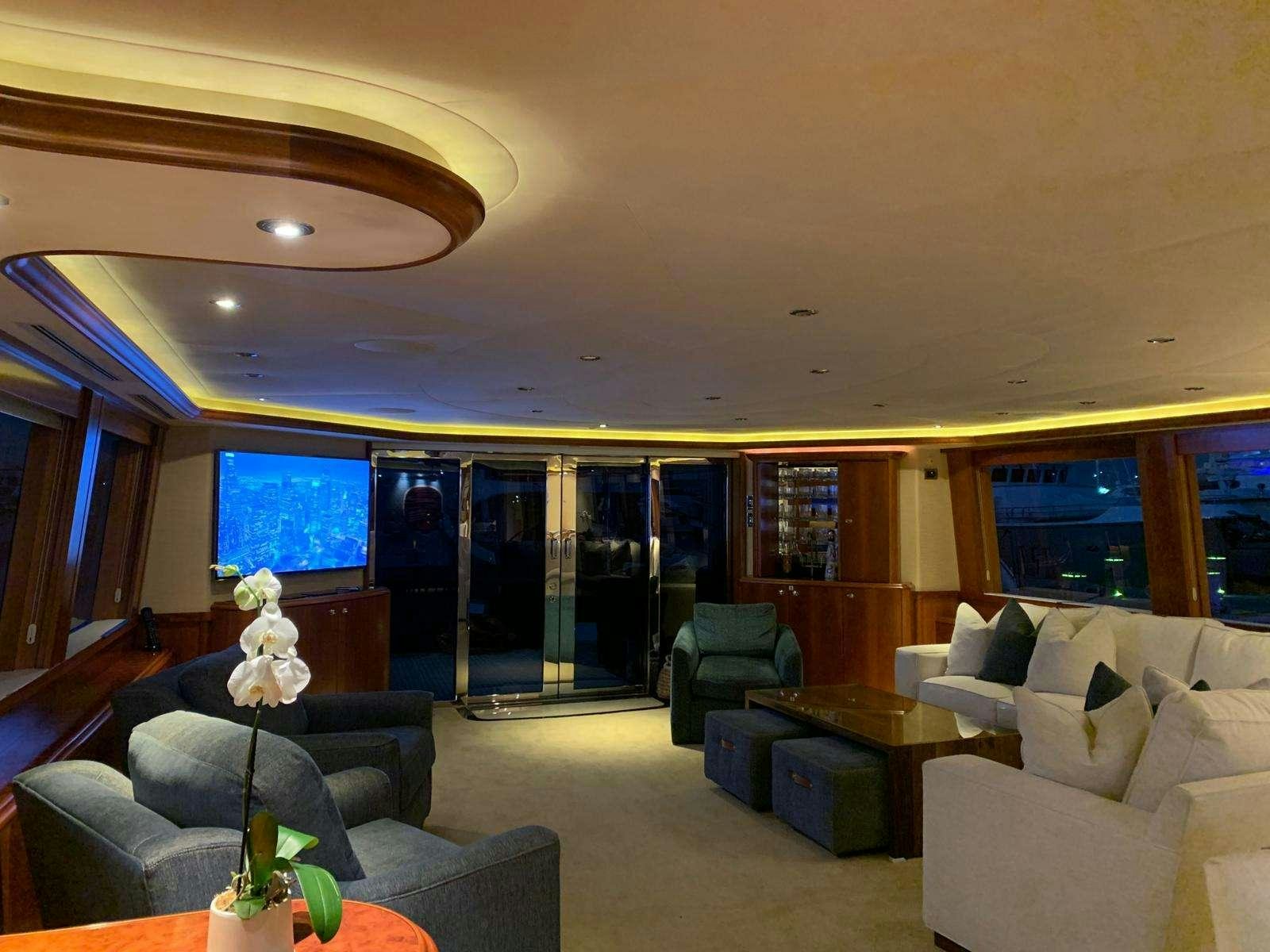 a living room with a large glass window aboard NATURAL 9 Yacht for Charter