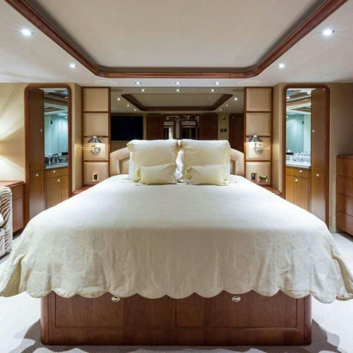 a bed with white sheets aboard NATURAL 9 Yacht for Charter