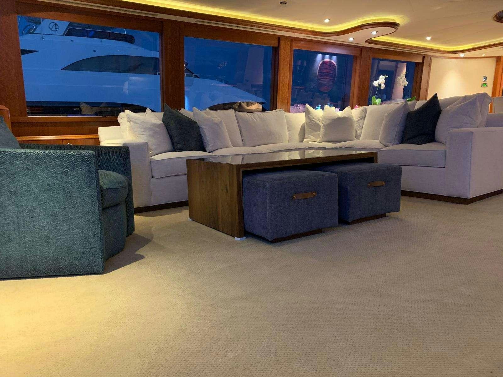 a living room with a couch and a tv aboard NATURAL 9 Yacht for Charter