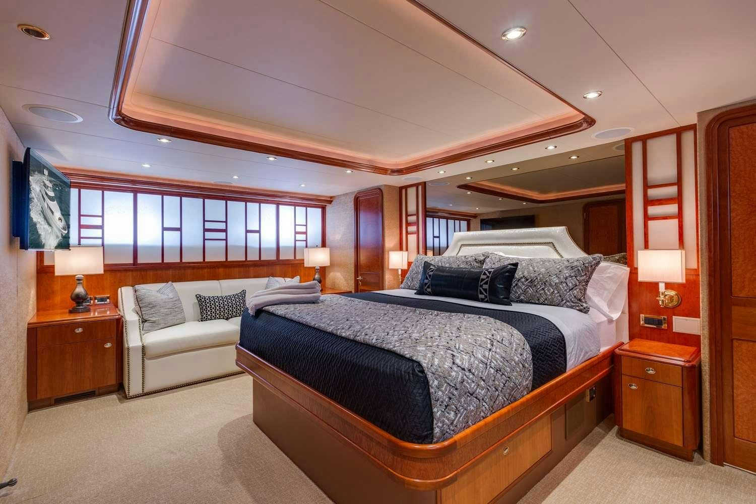 a bedroom with a bed and a couch aboard MY WAY Yacht for Charter